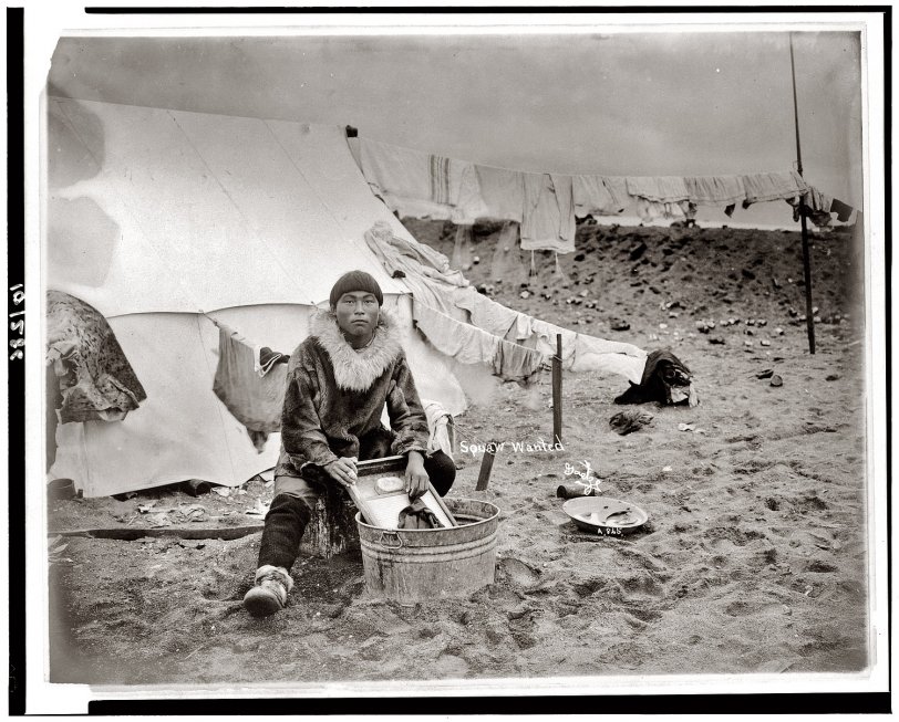 Photo of: Squaw Wanted: 1906 -- This circa 1906 photograph of a young Inuit man doing laundry (titled 
