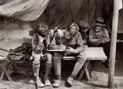 Hunter's Island, New York, circa 1912. "Boy Scouts at Hunter's Island. Writing to the folks at home." View full size. Underwood & Underwood.
