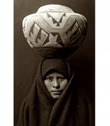 A Zuni Native-American girl with a pottery jar. Photograph by Edward S. Curtis, c. 1903. View full size.