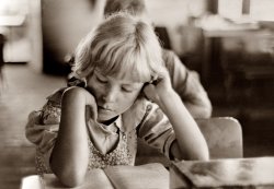 August 1938. "Child studying in school, Southeast Missouri Farms." Printed from a 35mm nitrate negative by FSA photographer Russell Lee. View full size.
