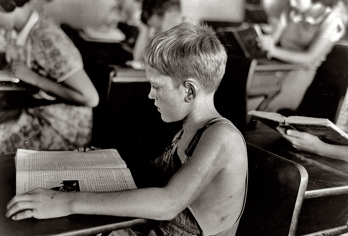 August 1938. Child studying in school. Southeast Missouri Farms, Missouri. 35mm nitrate negative by Russell Lee, Farm Security Administration. View full size.