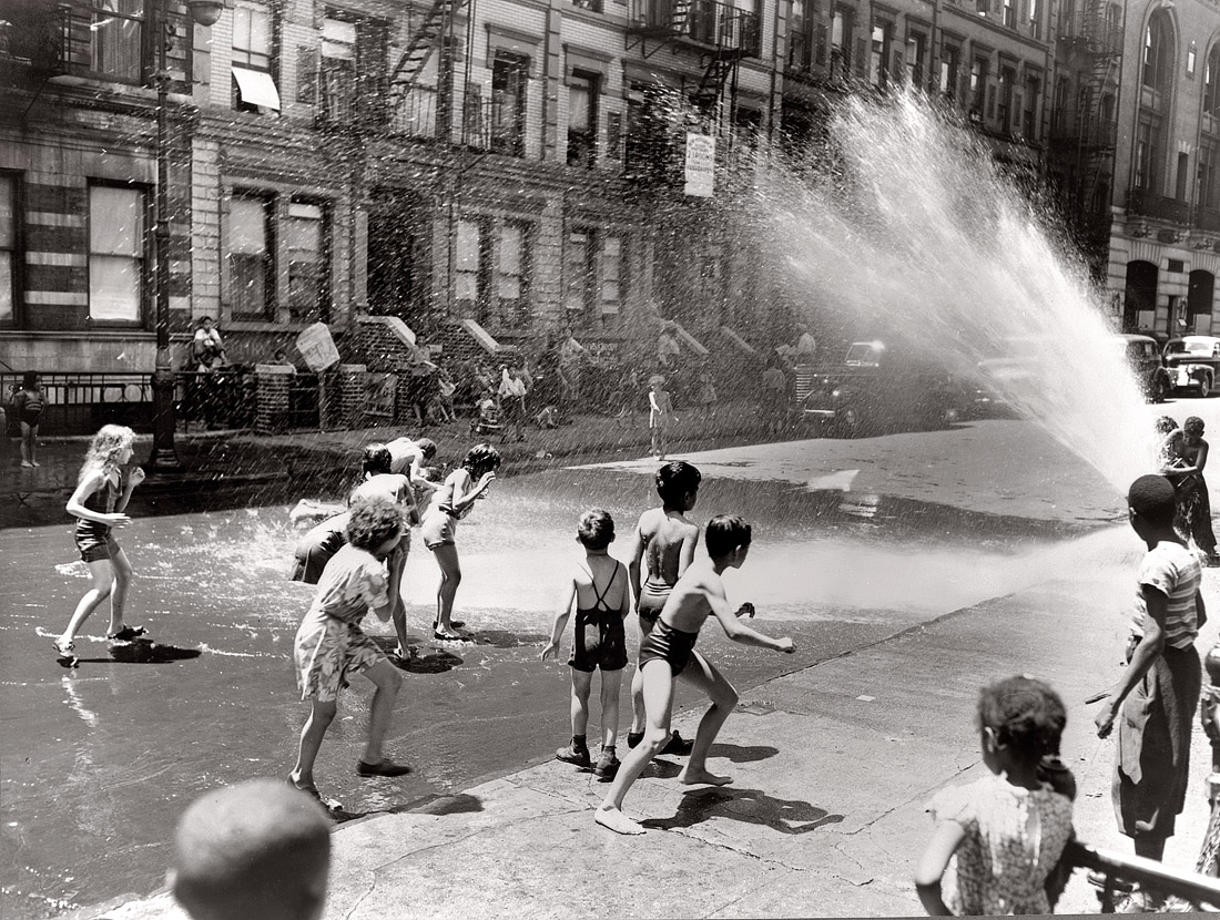 New York, June 1943. "Children escape the heat of the East Side by using fire hydrant as a shower bath."  View full size. Photograph by Roger Smith.
