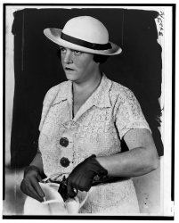 New York City detective Mary Agnes Shanley pulls a pistol out of her handbag. Shanley shows what awaits a pickpocket. She had more than a thousand career arrests. From the New York World-Telegram and the Sun Newspaper Photograph Collection, 1937. View full size.