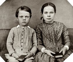 Circa 1850s sixth-plate daguerreotype, photographer unknown. "Unidentified boy and girl, three-quarter length, seated on upholstered bench." View full size.
