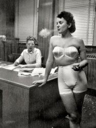 Chicago, 1949. "Woman standing in office, smoking while modeling undergarments." An early image from budding photojournalist and nascent filmmaker Stanley Kubrick. Look Magazine Photo Collection. View full size.