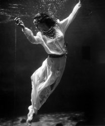 A fashion model underwater in the dolphin tank at Marineland, Florida. View full size. A similar image by fashion photographer Toni Frissell was published in Vogue in October 1939. Frissell had a knack for taking photos of women underwater. In 1947 she took another photo at Weeki Wachee Spring, which we posted as Lady in the Water. 