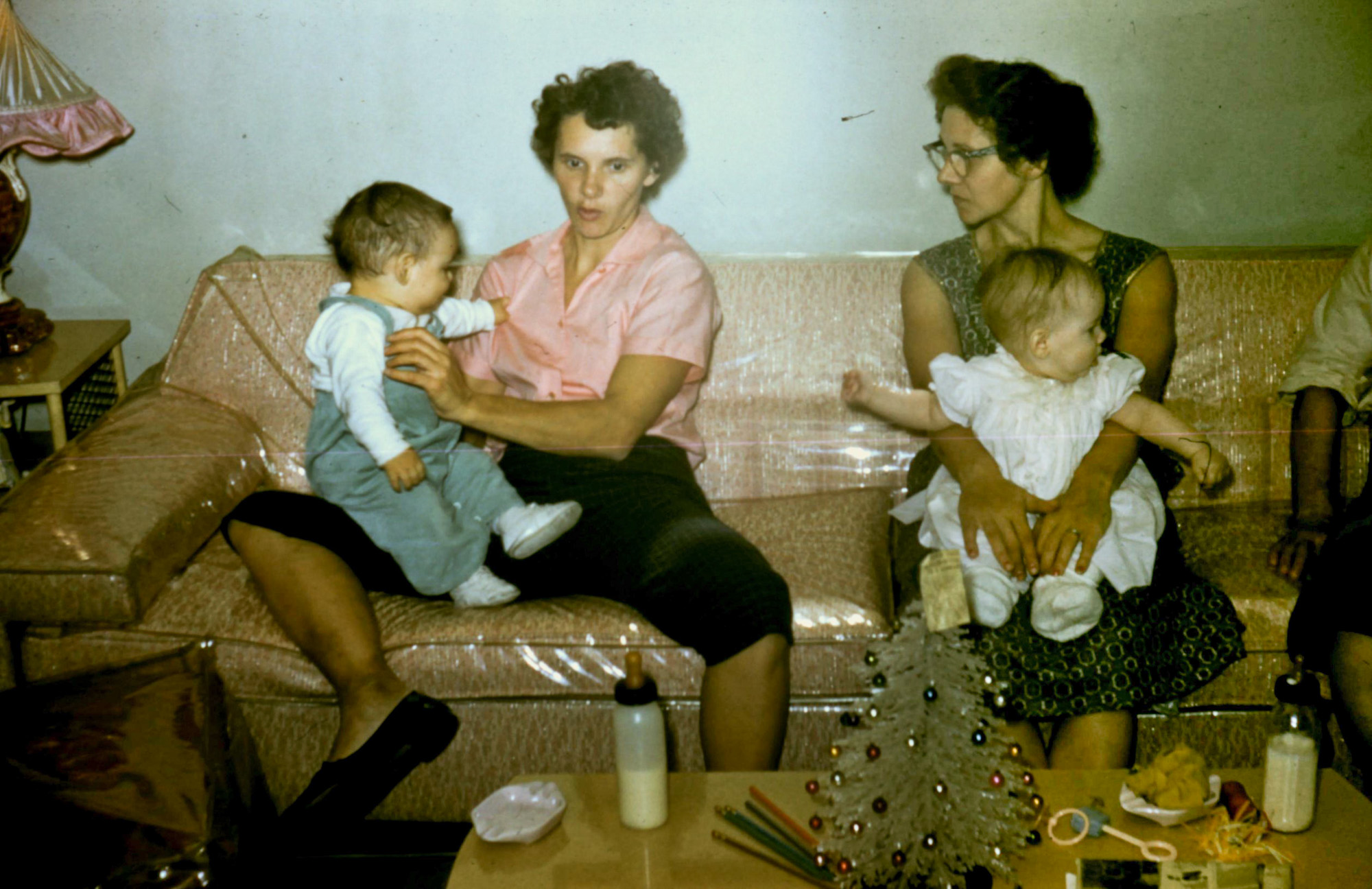 Kodachrome taken in my grandmothers living room. Her sister Marge to the left and my grandma holding my aunt Candy on the right. Taken during Christmas 1958 in Chicago Illinois. View full size.