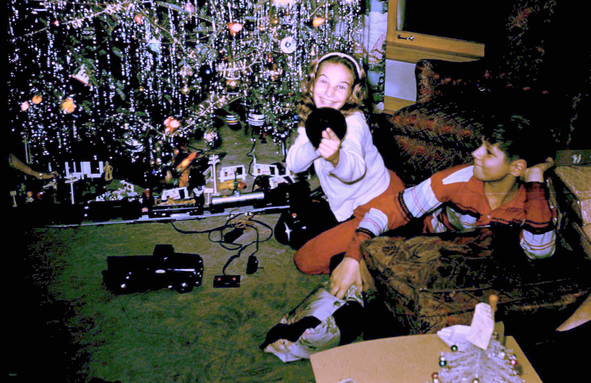 My father playing with his cousin and the Lionel train set he got for Christmas. He was about 8 here. Kodachrome slide taken in Chicago in 1956. View full size.