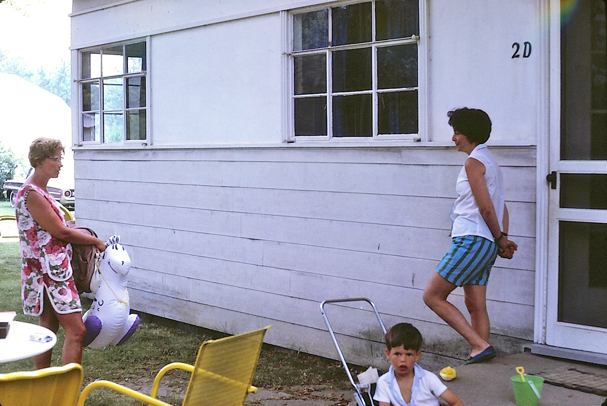 In August 1966, my family took a vacation in South Haven, Michigan and stayed at Sleepy Hollow Resort. Here my mom Louise (on the right) speaks to another guest while I sit in my stroller in front. View full size.