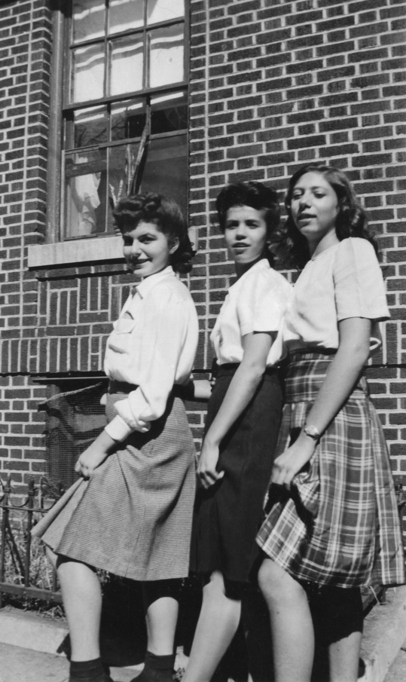 When Harriet was college age, my fourteen-year-old mother (far left) was in junior high school. Maybe she and her friends also sat on steps at their school, and read books. But here they hiked up their skirts, in unison, in front of my mother’s Brooklyn, NY apartment building, to show some knee. View full size.
