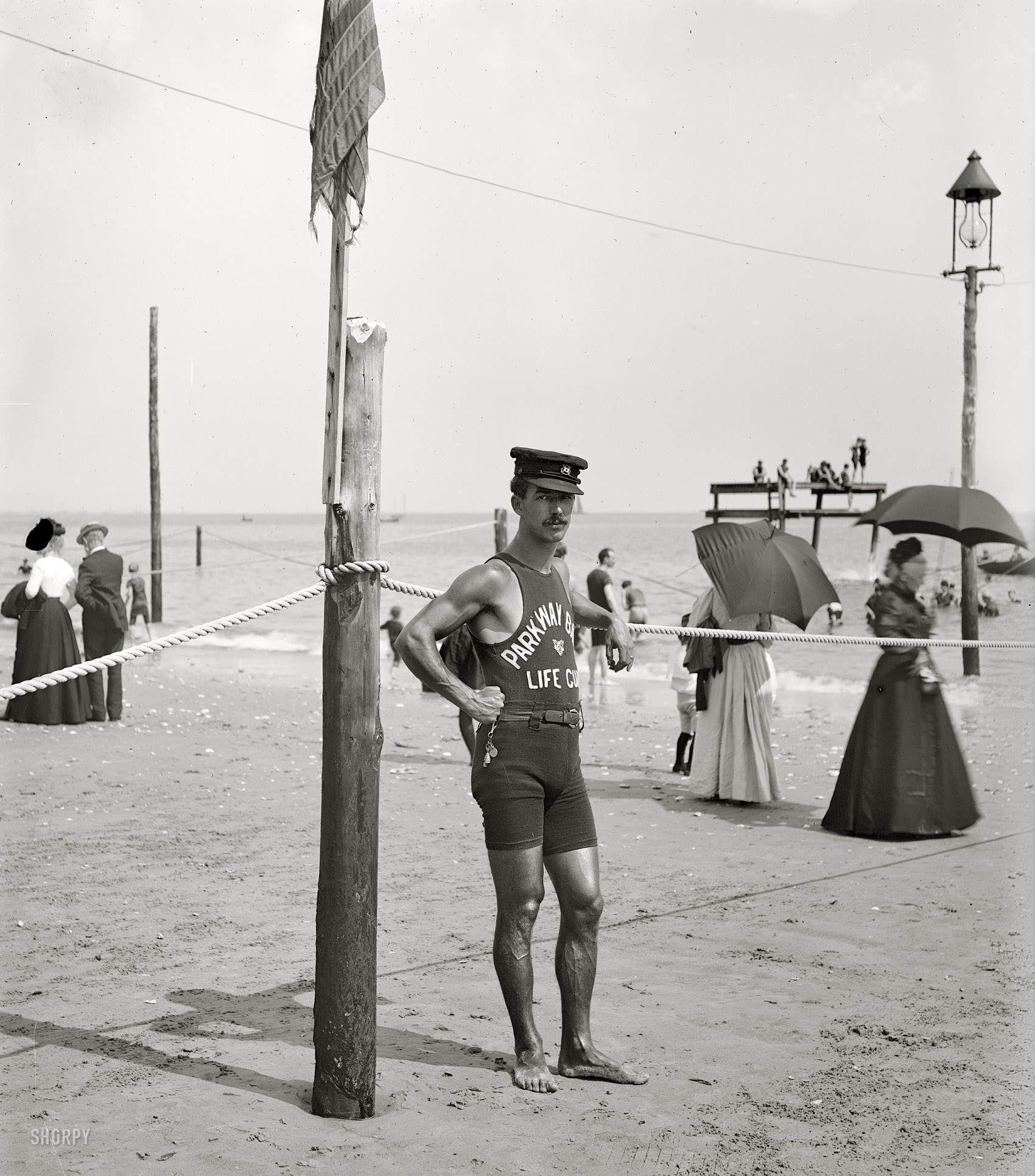Circa 1905. "A life guard. Brighton Beach, New York." He looks like someone who knows the ropes. Detroit Publishing Company glass negative. View full size.