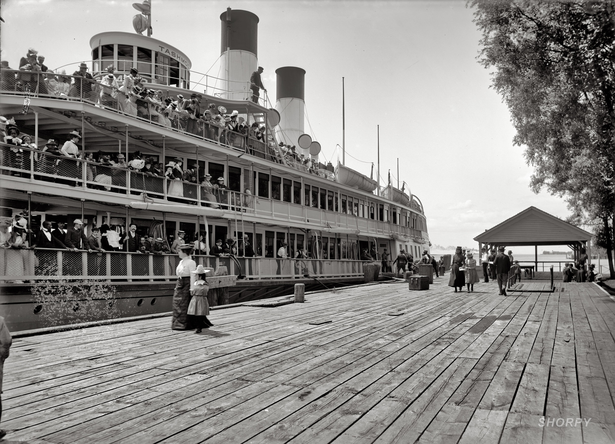"Tashmoo at the dock, Star Island House, St. Clair Flats," c. 1900-1901. The Detroit River excursion steamer SS Tashmoo, a sidewheeler, stopped at Tashmoo Park on the St. Clair Flats on trips between Detroit and Port Huron. A high point in the boat's eventful 36-year life was the night in 1927 that she broke free of her moorings in a winter storm and headed downriver on her own. Her end came in 1936, when she hit a submerged rock and sank. View full size.