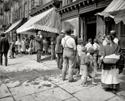 Circa 1900. "Heat wave. Free ice in New York." 8x10 inch dry plate glass negative by Byron for the Detroit Publishing Company. View full size.
Great TimingMy friends back East say it brutally hot just now, Hudson Valley included.
More than just comfortI would bet that most of these people are not going to use this ice for chilling their drinks. They're probably going to use it to keep their food from spoiling.
One thing about the present day is we continually go from hot to air conditioned environments during a heat wave.  In New York, no matter how cold it gets outside, the subway cars are usually cooled to the point of refrigeration.  This keeps our bodies from becoming acclimated to the temps.  These folks have been in the heat and have become somewhat adjusted.  The clothes they wear are probably all cotton or linen, both of which have the ability to wick the sweat away and help cool the body. I'm sure they're pretty miserable, but coping. 
You&#039;d get a line for free ice right nowWith temperatures hitting 101 degrees, in the middle of a l-o-o-ng week of 95+, you'll get plenty of people willing to stand in line for bags of free ice.
Ice cubes in a bowl + fan = poor man's air conditioning.
Thanks, Dave, for reminding us that some things never change, like NYC heat waves in the summertime. The children who grew up standing in those lines supported the construction of municipal swimming pools during the New Deal. They remembered!
Nostalgic and VintageI absolutely love old photographs, the older the better. You get to experience people, places and things frozen in time.
Sure this isn&#039;t Japan?The policeman looks like he's wearing white gloves. That would suck on a hot day like it appears to be in the picture.
Hot CommodityLater on, someone realized they could spritz it with food coloring and some flavored syrup and charge for it.
The Iceman (and Milkman) ComethBack in the 1940's in Newburgh NY in the midst of a summer heat wave, neighborhood kids would raid the back of the open ice delivery truck while the iceman would be tonging a block of ice to home ice boxes. Another source for kids, of small chunks of ice, was in milk delivery trucks while the milkman was delivering his wares. 
Weather&#039;s nice here in Monterey.It might have gotten to 65 here today.  
Staten Island FerryWhen my parents married in New York, in 1953, they stayed with a friend in Harlem. It was so hot and a neighbour was having a rent party so my parents took the Staten Island ferry back and forth all night long. Cool and quiet, compared to their friends' apartment.
I lived on City Island, in the Bronx, for two years and with no air-conditioning, and the ceiling fans not being up to the job, it was like trying to sleep in pea soup.
Trying To Imagine...what NYC must have smelled like with all of those sweating people and piles of horse manure in the streets makes me not want to go back in time to experience what is going on in the photo. This is a first in all my time as a Shorpy fan.
Melting PotTemperatures in Manhattan will probably go over 100 degrees today. It has been in the high 90s for the last few days and will be in or around the 100 degree mark for the rest of the week. There will be no free ice and the local utility, Con Ed, has started cutting back on the power so the air conditioners are not performing to spec. I think I'll go to a movie today, their sign says they're 20 degrees cooler inside. Incidentally, movie theatre air conditioning goes back to 1925 when Dr. Willis Carrier cooled the new Rivoli Theatre on Broadway.
Fishy, indeed!We are experiencing a real heat wave in New York today. I don't for a minute believe that the photo was taken in a temperature that comes close to our 100+
Look at the barefoot boys on that sidewalk -- there's your proof.
I got news for yahFree Ice? That's nothing special. Every February there is tons if it in New York. You just need to plan ahead a little.
Hats Year RoundUp until the 1950's or so, you will notice that headgear was always part of the dress code.  My dad wore a hat most of the year.  It had to be hot and uncomfortable.  
Something&#039;s FishyI can't believe all their icemakers went out at once.They need to call the super and complain.
Take it offThey sure are wearing a lot of clothes for a heat wave. I'd lose the jackets and long sleeves.
Barefoot tykesThat sidewalk had to be hot!
HatsA few years ago I bought a straw hat and It seems to actually make you feel cooler on a hot day.
Cool LidOnly a straw hat would make sense, or maybe one of these.
Poor timingHow about some lovely pictures of deep snow, ice-covered lakes, or something to make us feel cooler in today's hot weather?
The Long Hot SummerLooks like the cop has had a long day. As hot has his uniform is, my hubby now has to wear pretty much all that, except in polyester and with an extra 35 pounds of equipment, plus a bullet proof vest. It's been hovering around or at 100 lately here in Maryland, and his vest doesn't have time to dry out from sweat one day before he puts it on the next. So next time you see a cop sitting in his car with the AC on on a hot day, think of that guy up there! He could use a little break! (I hope he got hold of some ice chunks.)
Waaaaah!I love reading about the New York heat waves with temperature in the 90s or even 101 (!).  If it was in the 90s in Austin, we'd all be wearing parkas.  
Most of these people want Gordon Park!As in the last picture.
Even in these Victorian times you can see signs of the heat, the cop wiping his brow, most men in the derbies have them way back on their head to let the heat out, and the straw hat man doesn't because they let heat out, just as the Mexican and South East Asian farmers learned from history.
 I loved the snow cone comment, probably very right, why give the melting ice away if you can sell it!
Hot mamaSo I can see why they had the long pants, skirts and hats, but couldn't she have left the shawl off?
Hey, Austin tipster We NY/NJ SMSAers feel the same way about you guys when your highways are shut down after 4 or 5 inches of snow. We laugh at your puny "frozen precipitation levels" that seem to cause such chaos! 
Have you ever been on the Lower East Side, and seen these turn-of-the-19th-century former tenement neighborhoods? They are still standing: five- and six-floor walk-ups, built with no help from Mr Otis, crowded together on narrow streets. 
Even today, Austin's population density of 2600 people per square mile is less than 1/10th of New York City's (26,100). Crowding ten times as many people into every square mile raises the ambient temperature of NYC exponentially. When the weather report says "90" in a town of crowded, narrow streets with ten times as many people, it is a medical emergency.
Be grateful that, in your hometown, such temperatures make you reach for a sweater. It's not a sign of how much tougher Texans are in comparison to New Yorkers. It means that you are fortunate to live where the historical development patterns have provided you an environment where weather extremes aren't so dangerous to human health.
547Was looking for clues about the location of this picture and noticed the clothing store has "547" on the awning (alas no street name).  Looking closer you can see that "547" is also written on the inside of the awning and reflected in the store window.  But the reflection isn't backwards ... so perhaps it was written backwards so that people facing the window could see the non-backwards number in the reflection?  Very curious.
[The "547" on the outside of the awning would be backwards on the inside of the awning because it's the same "547" showing through the canvas.  - Dave]
(The Gallery, DPC, NYC, Stores & Markets)
