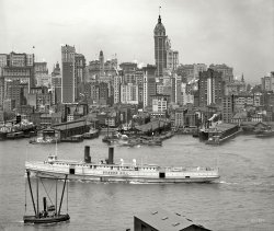 Manhattan circa 1908. "New York skyline." Part of an eleven-section panorama. 8x10 inch dry plate glass negative, Detroit Publishing Company. View full size.
White FlierFrom the pre-aviation era when "flier" meant fast ship. The Bunker Hill is an example of first quality American shipbuilding circa 1908.  While "modern" in terms of amenities, ships of this time were not required to carry sufficient numbers of lifeboats for all people aboard.  The Bunker Hill appears to be carrying four. 
Scheduled "White Flier" time for one-way passage between New York and Boston was 15 hours.



ABC Pathfinder Railway Guide, 1912 


Eastern Steamship Corporation
All-the-Way-by-Water
The Great Express White Steel Fliers Massachusetts and Bunker Hill.
Splendid Steel Freight steamships are operated by the Metropolitan Line between Boston, Mass. and New York.

The Massachusetts and Bunker Hill are notable examples of Modern Marine Architecture. Many of their staterooms are en suite, with connecting bath and toilet facilities. All staterooms are most attractively furnished, and equipped with the most modern sanitary fixtures. Inside staterooms are provided with electric fans. They are provided with a most attractive outside dining-room on the Main Deck, a Hurricane Deck Cafe; are equipped for the burning of oil as fuel, with Automatic Sprinkling Appliances, Wireless Telegraphy, Submarine Signal Service, and all other modern facilities to insures the Security and Comfort of passengers. All outside two-berth rooms, $2.00; Inside, $1.00. Electric Fans in inside room.

More of the NYC navyIf you look to the left side of the picture, those boxy barges lettered for the New York Central are lighters used to service ships in other parts of the harbor besides at the railroad's own dock facilities. This page gives a nice overview of the kinds of facilities in the city including a map that shows an overall picture of where they were. Containerization finally killed this kind of transloading off in the early sixties when someone finally figured out that giving the stevedores two passes on the goods wasn't exactly labor-saving.
Manhattan, 1908 on ShorpyAre you going to put up the other 10 sections of the panorama - they would be of great interest to Rail Marine modellers along with many others.
[It's on Shorpy's to-do list! - Dave]
The Flatiron&#039;s diminutive brotherwas the German-American Insurance Building, on Liberty Street.  It is now Louise Nevelson Plaza. Read all about it.
Re: Steampunk?Steampunk is fairly reasonable, but I see it more as "Metropolis" - and I don't mean Superman's version!
Steampunk CityThis image excellently represents the zenith of Steampunk USA -- look at all the plumes rising from the soaring skyscrapers, and the stalwarts of steam power on the mighty river.
A nation is coming into its own -- work is getting done.
Regard with awe the rising Manhattan silhouette –- all correct angles forming the canyons that will forever define the island, with just the right amount of added artistic flair that decorum &amp; modesty would allow.
This is at the very moment prior to the time when noxious internal-combustion engine -- fueled by the devil's excrement -- began its century of degradation &amp; domination.
[It was filthy, sooty coal that made the steam. The air over New York is a lot cleaner now. - Dave]
DazzlingThe former Bunker Hill in 1918.
City Investing BuildingStanding shoulder to shoulder with the Singer Tower is the picturesque City Investing Building, designed by Francis H. Kimball and built 1906-1908. This view, which I've never seen before, shows how close together they really were. Sadly both were demolished together in 1968 to make way for the US Steel Building (now known as 1 Liberty Plaza).
Had to happenThe day has finally arrived. I have been shorpyized, One look at this photo and I recognized the Singer building right away. Mother said there would be days like this.
NYC TugboatsThe New York Central boats are tugboats.  The NYC along with Jersey Central and I believe the B&amp;0, all operated tugboats which were used to move their RR barges to and from New York City.
South Street SeaportPier 16, along with the unseen Pier 17 out of the photo on the right, is now part of the South Street Seaport, so it's likely that many of the smaller buildings on the extreme right-hand side of the photo still survive! Pier 15 bit the dust at some point, though.
All Too HumanYes. So many wonderful buildings, of which few we see here survive. This, however, to me, seems to be a view of humanity of a past time. A photo taken from the same spot today probably wouldn't give you the same feel.  
&quot;Bizarre camouflage&quot; on former Bunker HillThat type of ship camouflage was called a "dazzle pattern."  It was widely used in WW I and also in WW II. Dazzle camouflage was meant to confuse attackers as to the ship's course and speed. It also confounded early range finders.
OK I wanna see the whole panoramaCan someone stitch it together?
[Have at it. - Dave]
Camo aheadSteamship Bunker Hill apparently became USS Aroostook, a mine laying ship, in WWI. The  naval historical center has an interesting series of photos of her. Some of the photos show a pretty bizarre camouflage pattern, too.
S.S. Bunker HillNew England Steamship Co. was the New Haven Railroad's dominant marine operator and served the islands of Martha's Vineyard and Nantucket from New Bedford. The Bunker Hill and others were overnight steamers to New England from New York.
More Singer!Thanks for yet another great photo of the old Manhattan skyline with the Singer Building in it.
What&#039;s that building?What's that Flatiron-looking building just to the left of Rogers &amp; Pyatt Shellac? I wonder if it's still standing.
50 storiesThat Singer building dominated the skyline back in the day. Many buildings in NYC are 50 stories and over now, but it would be still be a very interesting landmark structure if it survived today.
1908 ShellackingFor best quality shellacking … 



Stubbs Buyers Directory for the Wholesale Drug, Chemical, and Allied Trades, 1918 



 Rogers &amp; Pyatt Shellac Co.
79 Water St., New York. 
[Suppliers of:]

 Gum Copal
 Gum Kauei
 Gum Sandarac


Horizontal vs verticalThe long white boat and its wake make a pleasing and flourishing contrast with all the vertical lines.
Where would those "New York Central" boats have been going to/coming from? Do they connect with the railroad? Were they taking passengers across the river?
Steampunk? Really?Hey I know the internet has to reuse the same old boring subculture buzzwords over and over again but stop misusing the term "steampunk."
The Industrial Revolution wasn't about form over function.
[So I suppose we could call you Anti Meme. - Dave]
For Tim DavidOk, it's not quite perfect, but HERE is the full panorama.
Aroostook ConversionBelow is a before/after image of the Bunker Hill/Aroostook refit. (Stitched from the above Shorpy post and the image at Wikipedia, flipped left-right.)
Old NYCI love drawing old NYC and I love Shorpy.
Check out my site for more.
www.erosner.com
ManhattaI bet Manahatta was given the nickname The Big Apple because of all the road apples on the streets. Come for the stunning architecture, run away gagging from the smell. 
What I'm learning from this phenomenal site are the minimal changes from Civil War customs and architecture up through the 1910s. Regardless of incredible inventions, social norms hardly shifted at all till WW1. 
Yes!I would also like to see the entire panorama. Even if bit by bit. 
Someone say Panorama?Sorry for a bit of a screw-up where the Harbor starts on the left side because Photoshop has a bit of a malfunction, but here's the full panorama. Enjoy! 9528x960

(The Gallery, Boats & Bridges, DPC, NYC)