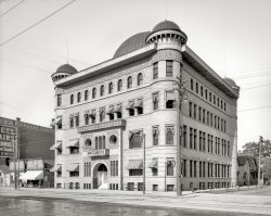 Port Huron, Michigan, circa 1905. "Maccabees Temple." Lodge of the fraternal order Knights of the Maccabees. Detroit Publishing glass neg. View full size.
After the PhotoIn 1906 the Maccabees built a new temple about a half mile from here.  This building became the Algonquin Hotel and for many years was the swankiest place in town.  The building burned down in 2000.
R.I.P.So sad -- this Moorish Sullivanesque building is no more.  It is interesting to note that its surroundings had not appreciably changed after 95 years. To the left are two single-story storefronts and to the right is a frame house.
(The Gallery, DPC)