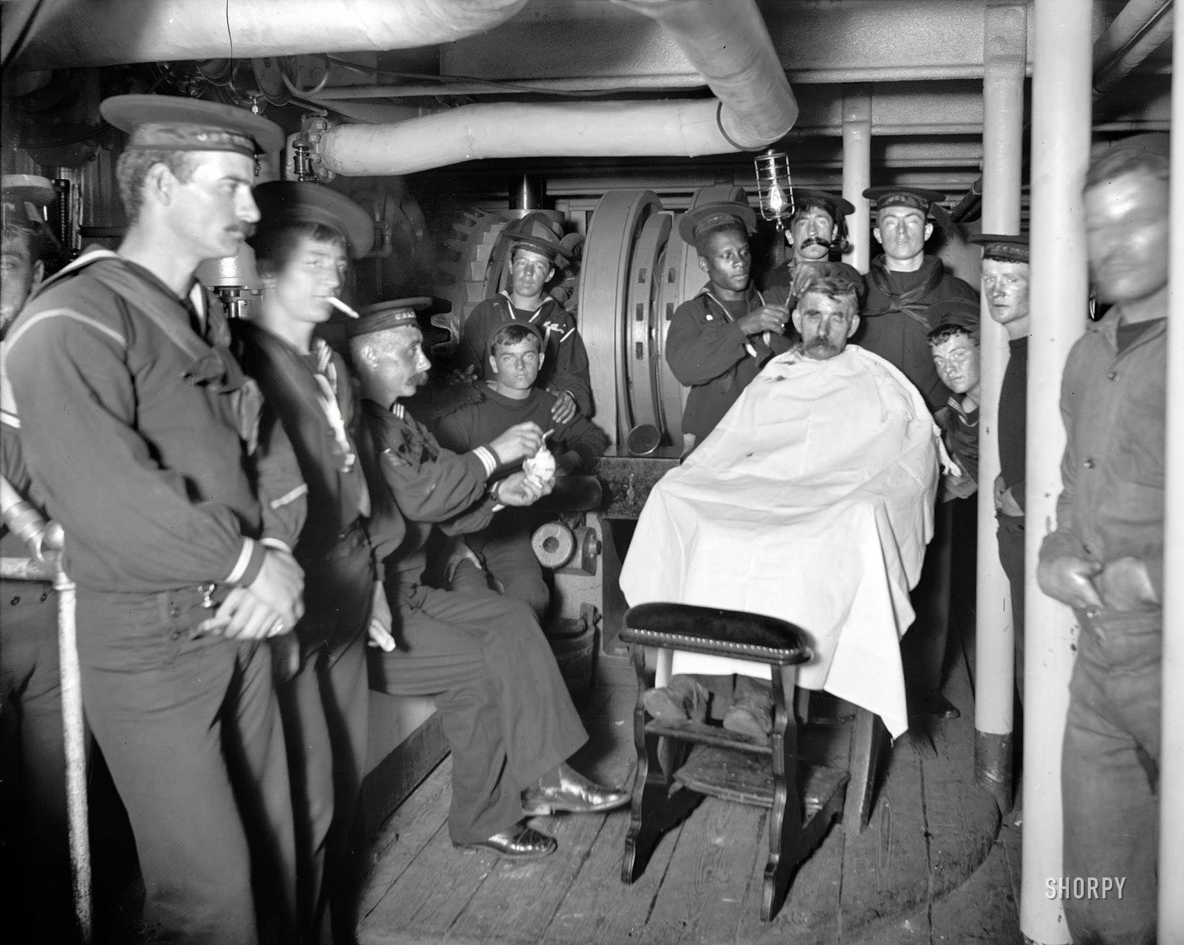Aboard the U.S.S. Brooklyn circa 1898. "Barber shop." Where a sailor goes to get his topsail trimmed. 8x10 glass negative, Detroit Publishing Co. View full size.