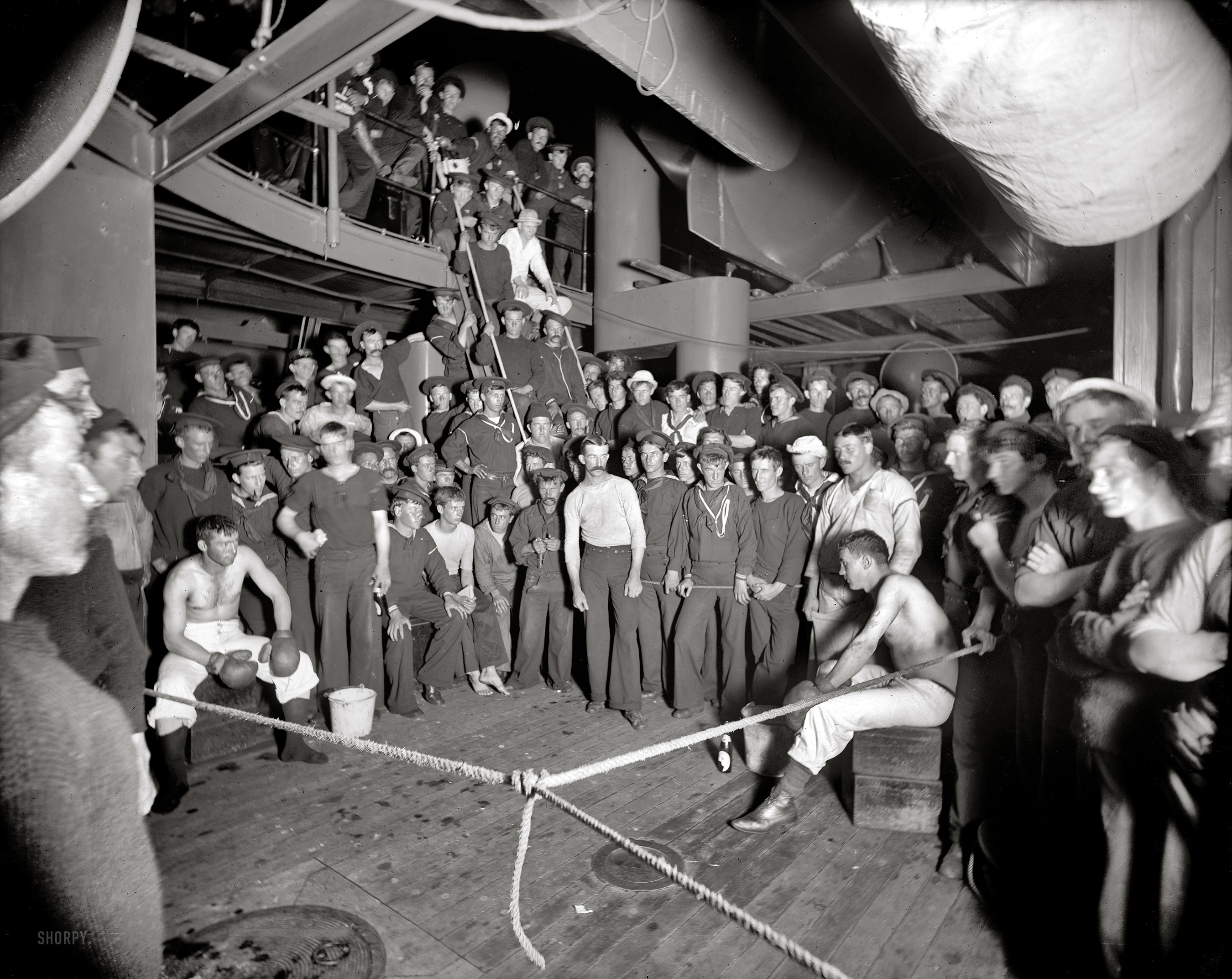 Aboard the U.S.S. Oregon circa 1897. "Waiting for the gong." 8x10 inch dry plate glass negative by Edward H. Hart, Detroit Publishing Company. View full size.