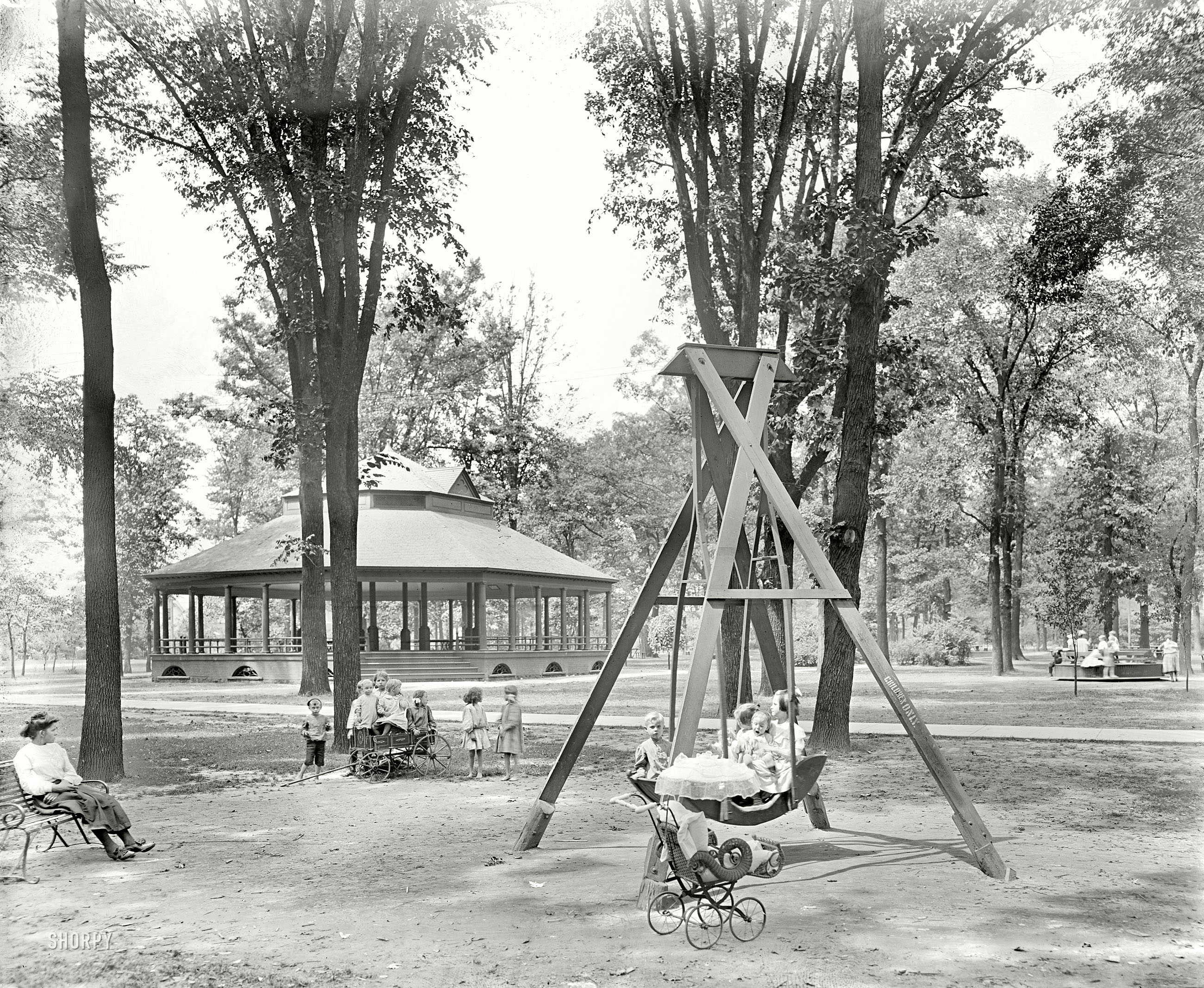 Detroit, Michigan, circa 1900. "Scene in Clark Park." In the background is merry-go-round we saw a few days ago. 8x10 glass negative. View full size.
