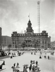 Detroit, Michigan, circa 1900. "City Hall and Campus Martius." To the left, the Soldiers and Sailors Monument; rising to the right is one of the city's "moonlight tower" carbon-arc lamps. Palm trees and bananas strike a tropical note. 8x10 inch glass negative by Lycurgus S. Glover, Detroit Publishing Co. View full size.