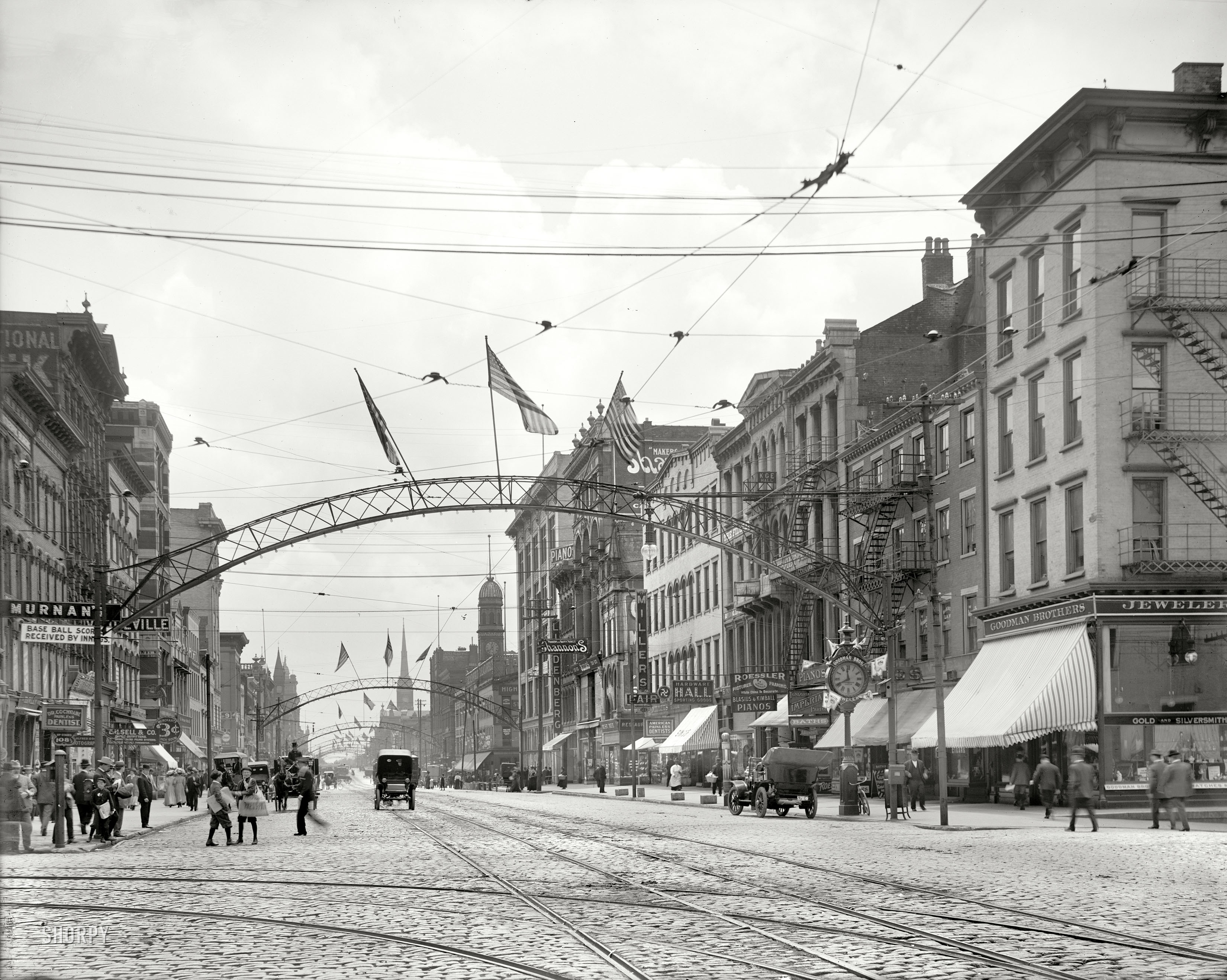 Columbus, Ohio, circa 1910. "High Street, south from State." Where strollers have, among many available choices, a 3-cent lunchroom, the Imperial Tonsorial Parlor and Baths, "base ball scores received by innings" and swastika sporting goods. 8x10 inch glass negative, Detroit Publishing Company. View full size.