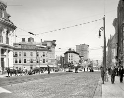 Utica, New York, circa 1910. "Genesee and Bleecker streets." Points of interest include the City Candy Kitchen, City National Bank, a streetcar control tower and the Commercial Travelers building seen in an earlier post. View full size.
