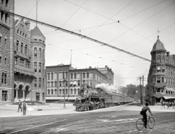 Syracuse, N.Y., circa 1905. "Empire State Express (New York Central Railroad) coming thru Washington Street." Detroit Publishing Company. View full size.