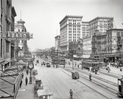 Canal Street in New Orleans circa 1910. Large building is the Maison Blanche department store. 8x10 glass negative, Detroit Publishing Co. View full size.
Canal and CarondeletThis photo was taken near the intersection of Canal and Carondelet. All the buildings on the far side of the street are still there, although the left side is considerably different. Fascinating stuff.
Glad-U-KumNow this is one happening street!  Love the signs over the street.  Can anyone ID the car heading our way?  Almost looks like it's a "Glide" or "Slide" (whatever that is).
So, that&#039;s where I went wrong.Just thinking how different my life would be if I had some of those smart clothes.
Glide pathWonder why the Glide car is the only conveyance visible not powered by horse or electricity? Surely Noo Orleenz had lots of cars by 1910. Also, anybody hoping to end it all by jumping off the roof of that fantastically ornate building on the right might spend some anxious moments volleying up and down on the jungle of wiring covering much of the street. Maybe grab onto a handy gargoyle after six or seven bounces, with second thoughts about departing the Big Easy so soon.
Didn&#039;t Little Orphan Anniequote "Leapin' Lazards" ?
K&amp;BI just wanted to comment that the drug store on the bottom left - Katz and Besthoff - became a big local chain called K&amp;B that was like a Walgreens or CVS. It went out of business so time in the early nineties I think. There corporate office had a substantial art collection that I believe is now part of the Odgen Museum of Southern Art and the sculpture garden in City Park. I could have some of these details confused. Anybody know what the Winter Capital of America Banner draped across the street refers to?
[New Orleans! - Dave]
Who needs to drive?I see no fewer than 16 streetcars in this photo!  Talk about mass transit!
&quot;A Confederacy of Dunces&quot;In the opening scene of John Kennedy Toole's novel, Ignatius J. Reilly stands (many years later) in front of the D.H. Holmes across the way.
Smart Clothes!Ooooh I need some because I've been feeling like a dummy lately. :P
I am so happy to see so many ladies! Normally all the ladies are MIA in Shorpy photos (already drinking afternoon tea or working?) Oh all the outfits and dresses!! *drool* Everything from fancier day/walking outfits to typical white blouse &amp; black skirt combo for the new working generation.
And did anyone else notice the huge umbrella on a pedestal in the middle of the street? There for a rainy day?
This is beautiful!Try putting *this* in a movie today, even with CGI.  I can about hear the chatter of voices, the hoofbeats, the bells on the streetcars -- I count at least a dozen streetcars just in this short stretch of street!
Little girl, in the dark dress at the far left, where's your mother?  You shouldn't be out here all by yourself.  (Thinking about it, that little girl was just about born with the century.)
Why is there an umbrella on a stand in the middle of the street?
Through my Grandfather&#039;s EyesWhat a wonderful photo - taken the same time my grandfather lived in New Orleans.  I couldn't help wondering if he was among the busy pedestrians.
Regarding WINTER CAPITAL sign - the South has always been a popular destination for the well-to-do Northern crowds in the winter - we call them Snow-Birds.  I'm sure that New Orleans with its excellent railway and boat connections was one of the most popular destinations. 
FascinatingThere is so much going on in this picture, you could lose hours poring over it.  Strange to think that all these people going about their daily business are no longer with us.
Katz &amp; BestoffI also love the shot of Katz and Bestoff. This would have been their flagship store, established in 1905, although this year, 1910, a second store opened across the street at 837 Canal. K&amp;B grew to 177 stores across the deep south, before being sold in 1997 to Rite Aid. Anyone in New Orleans still refers to K&amp;B purple, as this started in 1908, when the owners bought a bulk lot of unwanted purple paper, and used it for wrapping, etc. Part of the K&amp;B jingle, "Look at almost any corner, and, what do you see? A big, purple sign that says, friendly K&amp;B!"
This is Beautiful, IndeedYup, sixteen streetcars, which, while being pedantic but wishing to throw out a bit of cocktail party trivia, I would offer do not have bells, but have gongs.  
Suspect the umbrella was to shade a streetcar dispatcher or perhaps a traffic cop.  It looks like high noon, so it's probably not too effective just now.  Or the shadee is in to lunch!
Santa &amp; Mr. BingleIn the early 1950s our parents would take us to Maison Blanche for photos with Santa and his buddy Mr. Bingle. MB had a really good Santa and almost 60 years later I can still remember the visits.
The smellsHave been trying to conjure up the smell of this place.  Horses, rickety gasoline engines, wafts of ozone, what else is there?  Must have been pretty unique, especially in those New Orleans summers.
24 hour drug store at the right.  Everything old is new again.  And mailbox technology has not changed at all.
Forget the umbrellaI wanna know what the closed cart (not a wagon, they have four wheels) parked in the middle of the street is.
[One way or another, something to do with horses. Watering then (note the dipper) or cleaning up after. - Dave]
Adler&#039;s TimeAdler's is a multi-generational family business selling jewelry and gifts.  The store and its beautiful sidewalk clock are still there today.
A Fez-tive timeThe "GLAD=U=KUM" banner is for the Shriners' 36th Imperial Council Session in New Orleans April 12, 1910. Here is a souvenir of the occasion.
Williams&#039; PharmacyThe four-story building was owned and run by Captain Williams who was a Civil War veteran.  My great uncle, Adolph Kaczoroski was his manager for 30 years from 1895 to 1924.  The building's soda fountain was especially popular.
Luzianne Coffee"Luzianne" a dialectical play on Louisianian?
[Since 1902. - tterrace]
Then and nowThe clock on a post here is in front of Adler's Jewelry Store. At the time of this picture, the location at 722 Canal Street must have been only recently opened. The original location (1898) was in the first block of Royal Street, but after a fire in about 1904, the business spent a few years at 810 Canal Street before moving to its present location where it still operates today. I think of everything you can see in this picture, Adler's is the only business this old New Orleans scene that you can still visit today and is still operated by the Adler family. In fact, the Adler family owns both the original K&amp;B location, mentioned above in another comment (today a FootLocker,) and the Williams Pharmacy building (soon to be a pharmacy again with a historic renovation that will be done by Walgreens.) The clock was moved from the pole to the awning of the store in the 1920's and both are still there today. The awning also has remarkable historic detail with a fleur de lis motif that is hard to see in the picture here, but is definitely there.
Amazing Picture!!!
K &amp; B DrugsstoreI remember this oh so familiar drug store.  And the undeniably K &amp; B purple.  Only those from this great city know the shade of K &amp; B purple.  
Williams Pharmacy My 2nd great-grandfather, John Morin, was a druggist at Williams Pharmacy from about 1900-1913 when he died of a heart attack in the pharmacy.  
(The Gallery, DPC, New Orleans, Stores & Markets, Streetcars)