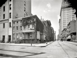 New York circa 1905. "Washington Irving's home, Irving Place and East 17th Street." Where Rip Van Winkle meets Sleepy Hollow. 8x10 inch dry plate glass negative, Detroit Publishing Company. View full size.
Hydrants high and lowA little trivia:  This area was transforming from residential to manufacturing lofts at about this time.  (The transformation never got much past 17th Street on Irving Place, though).  For a period, the city ran two separate fire hydrant systems, one for everyday use, and a high pressure system for commercial areas that could push a lot more water into high-rise buildings.  The short, fat fire hydrant in the foreground is the high-pressure system; the taller, skinny one in the background is the regular system.  
The high-pressure system went out of service in 1979, but the hydrants remained on the streets for decades, "downgraded to the simple duty of collecting parking ticket revenues for the city." You could still find them around Union Square into the 2000s.
Creepy Face CloudThe cloud in the middle of the picture looks like a ghostly  figure of a little girl just look closely is creepy you can see the head and hands!?!
Elsie de Wolfe&#039;s PlaceAlthough Irving Place was named for Washington Irving, the long identification of this house at 122 E. 17th Street is apparently incorrect. The story seems to date from the 1890s, when the house was occupied by Elsie de Wolfe, the influential and very social interior designer, and her partner Elisabeth Marbury, a successful literary agent. Built in 1844, the house had once been the residence of an unrelated merchant named Edgar Irving, and Washington Irving lived in Tarrytown, not Manhattan, after his return from Spain in 1846. A 1994 New York Times article by Christopher Gray debunks this durable myth in killing detail.
Whaddya KnowStill there.  Along with much of the neighborhood.  I was sure I'd hit Google Maps and see a '70s apartment complex or a parking garage.  There oughta be a medal.
Old and ImprovedI don't know that I have ever thought this on this site, but I actually think the scene looks better now!  Aside from the addition of the big ugly box of a building across the street, the trees and removal of the ivy is beautiful.
View Larger Map
And let&#039;s not forget Washington Irving High SchoolStill a great NYC public high school! Famous alumnae include Claudette Colbert, the famous 1930's movie star, and Gertude Berg, of "The Goldbergs" TV show of the 1950's. Today, great kids and teachers.
+107Below is the same view from April of 2012.
(The Gallery, DPC, NYC)
