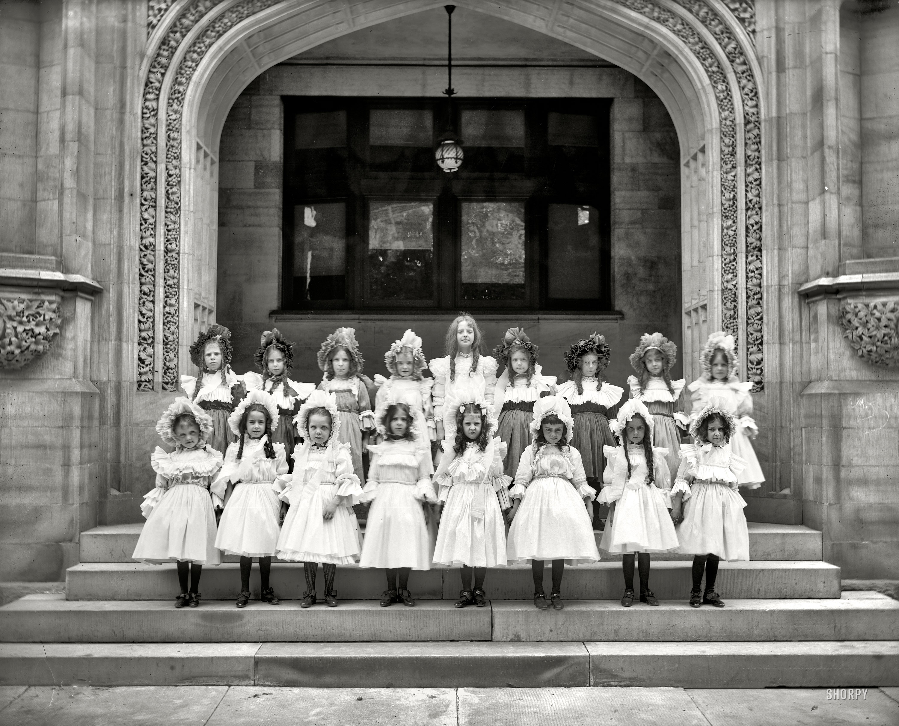 Circa 1905. "Schoolgirls." Our second group portrait taken at this undisclosed location. A mute choral recital hitting all the notes on the scale of emotions between embarrassed and mortified. Detroit Publishing Co. View full size. UPDATE: This is the Saints Peter and Paul Academy, 64 Parsons St., Detroit.