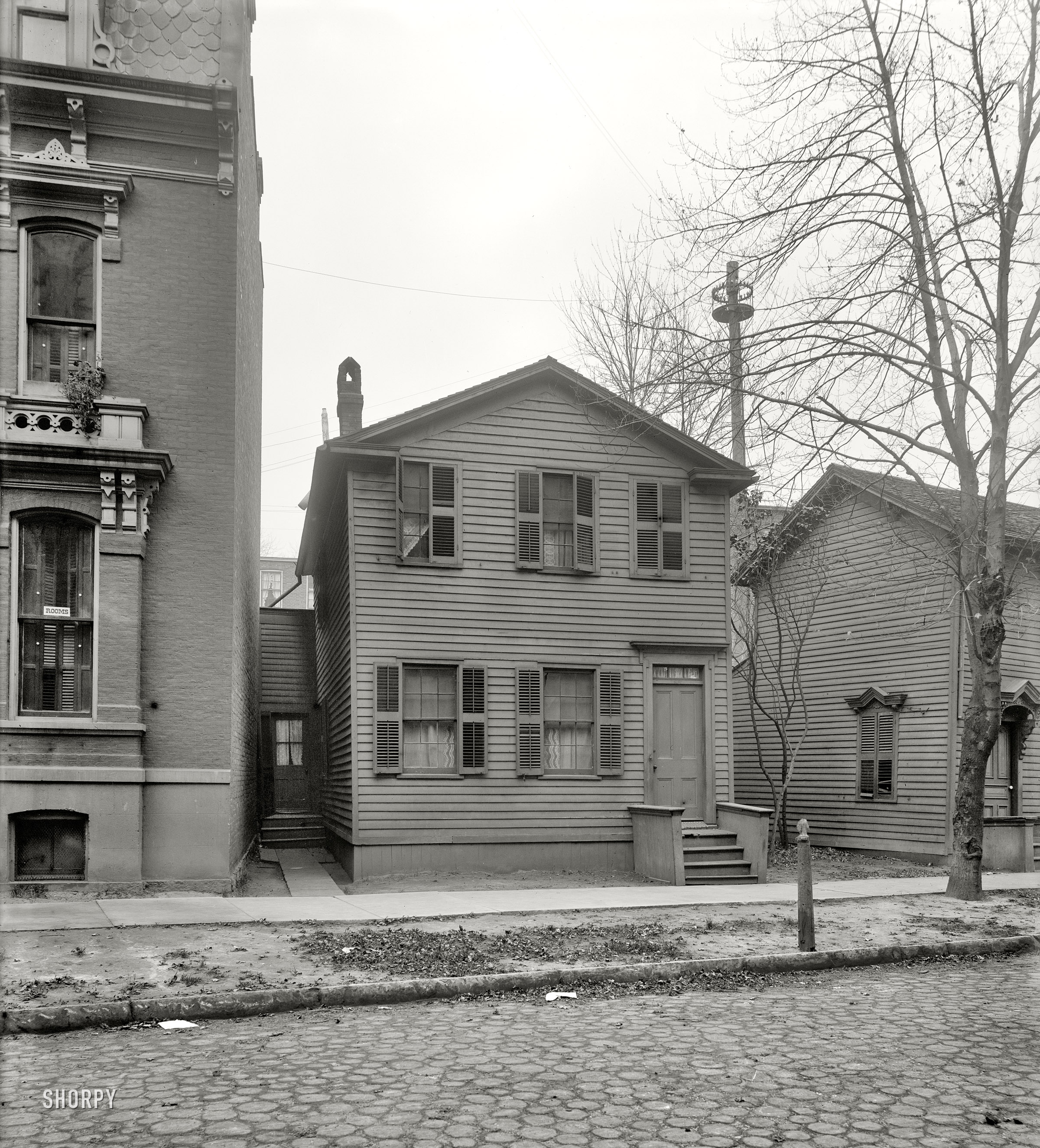 Detroit, Michigan, circa 1910. "No. 33 Center Street." Why this little house is in the Detroit Publishing archive is a mystery to me. Note yet another of those maypole-style telephone line drops. 8x10 glass negative. View full size.