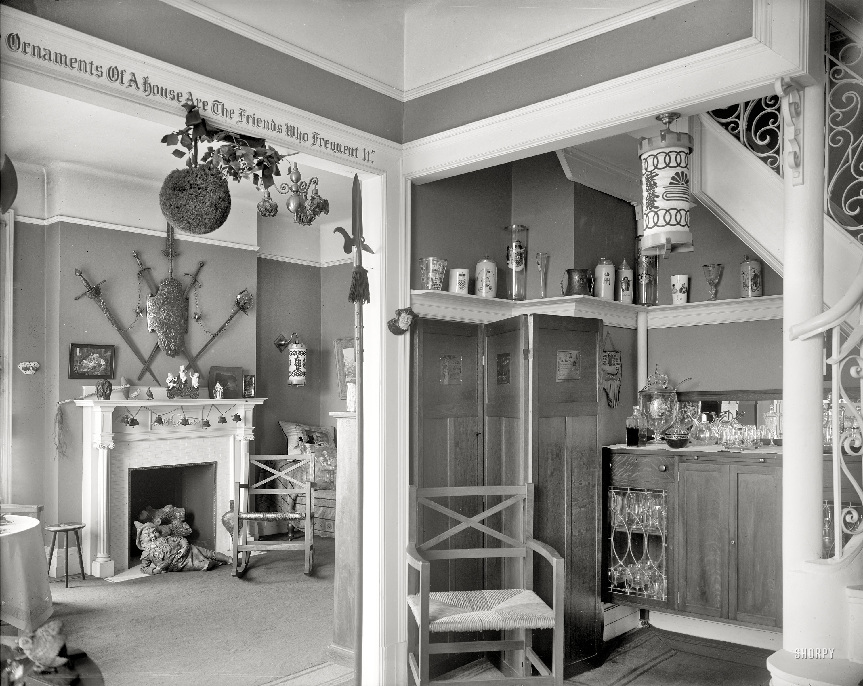 Circa 1915. "Hallway with liquor cabinet and living room decorated with mistletoe ball and Christmas gnome by fireplace." Detroit Publishing Co. View full size.
