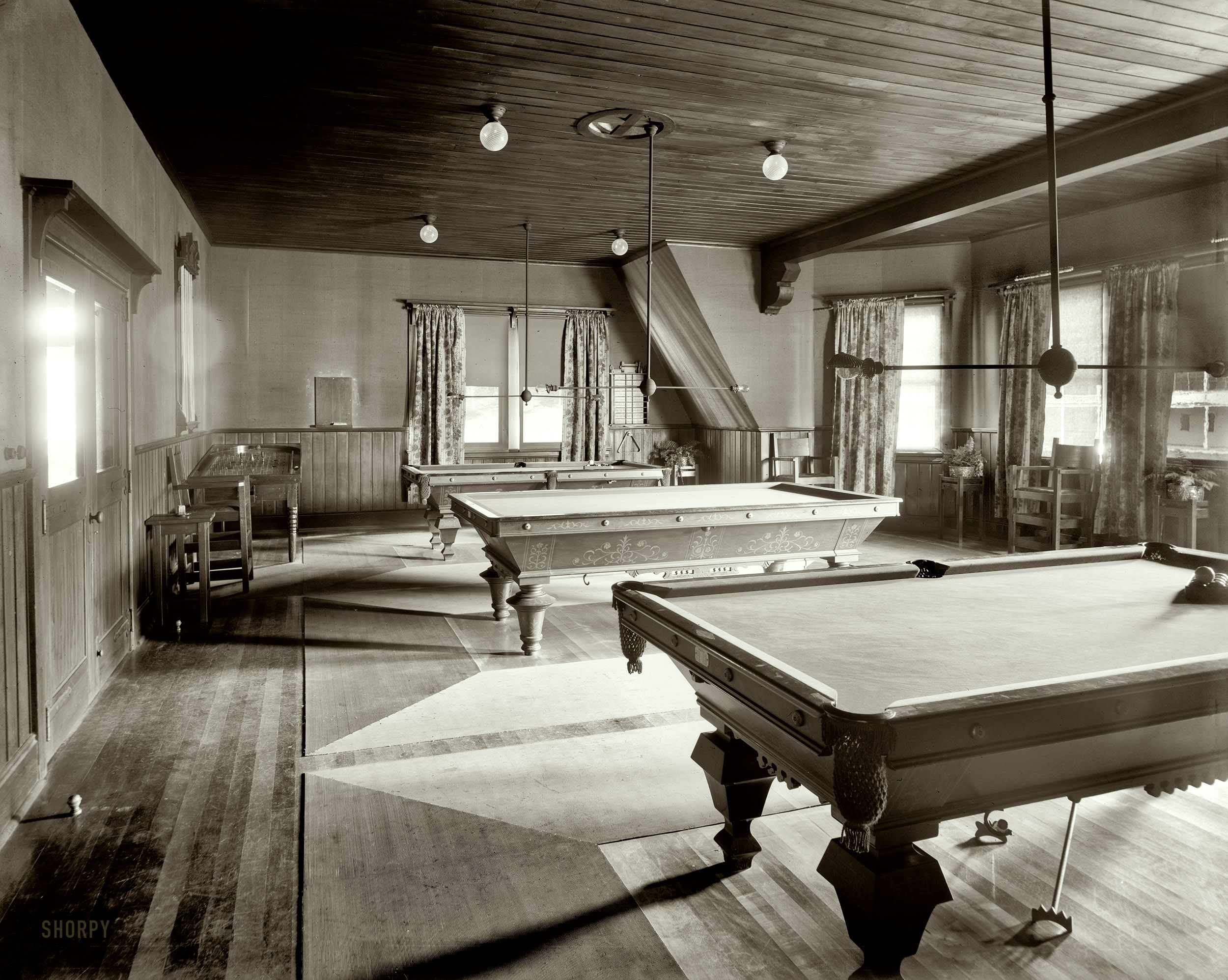 Upstate New York circa 1905. "Billiard hall at Paul Smith's casino, Adirondack Mountains." Note the pinball table in the corner. 8x10 glass plate. View full size.