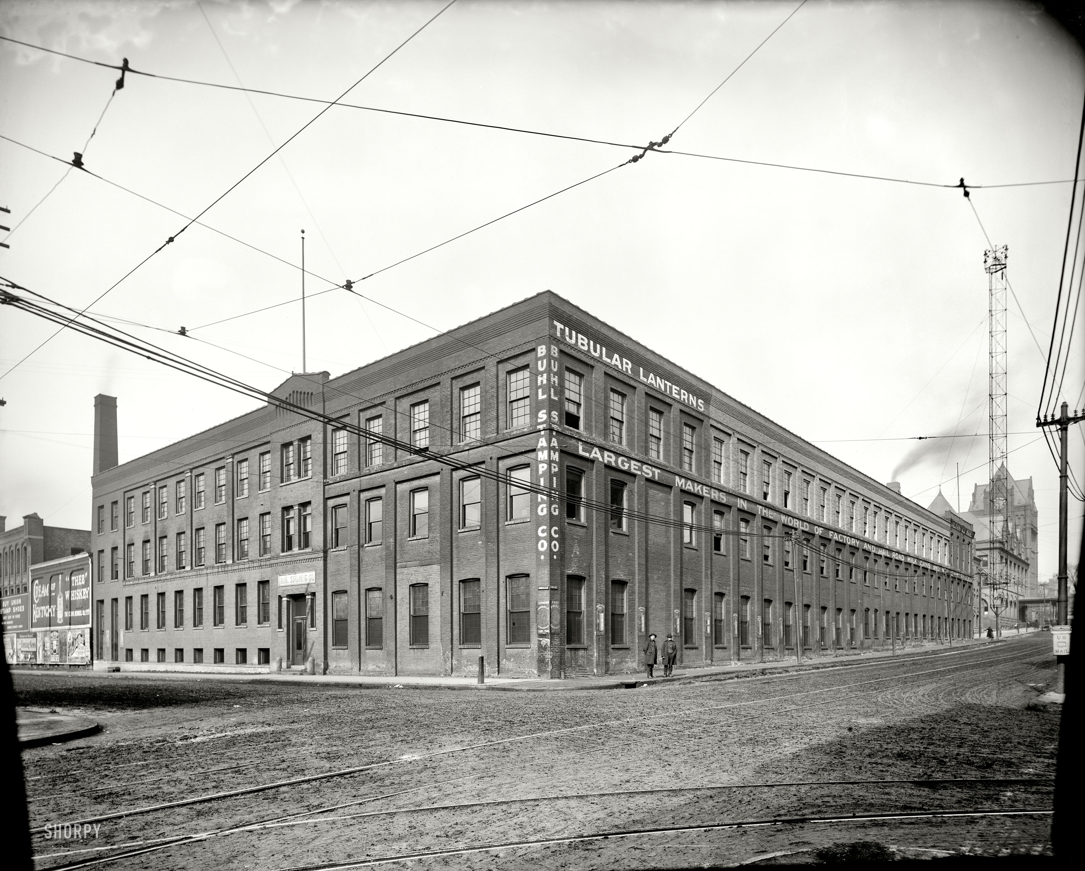 Detroit circa 1905. "Buhl Stamping Co., 3rd Ave. and Larned." Note the "Cheese Factory" milk cans illustrated between the windows, and the arc-lamp "moonlight tower" to the right. 8x10 glass negative, Detroit Publishing Co. View full size.
