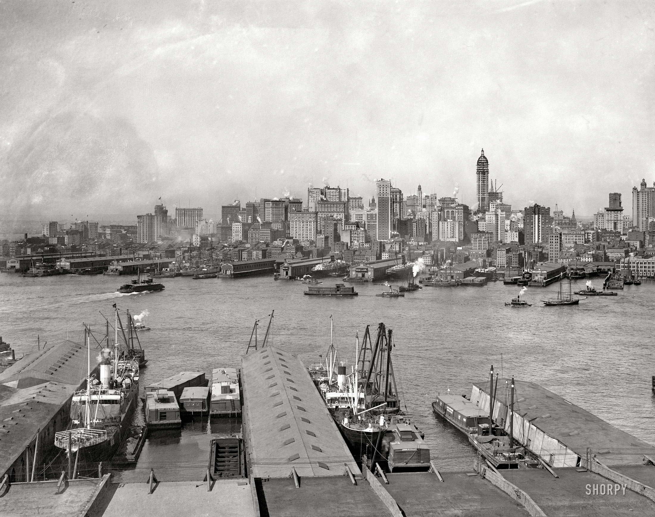 Circa 1907. "The heart of New York (Manhattan skyline from Brooklyn)." The Singer Building rises. 8x10 glass negative, Detroit Publishing Co. View full size.
