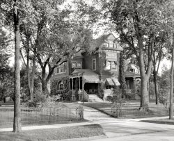 Saginaw, Michigan, circa 1907. "Dr. Henry C. Potter's residence." 8x10 inch dry plate glass negative, Detroit Publishing Company. View full size.
The house knows how to accessorizeI love the windows and awnings. You don't see windows all dolled up like that anymore. Not on the outside anyway.
I&#039;d live thereBut only if I could afford a housekeeper.  And she better do windows, too.
Southern ExposureBefore air conditioning was common, south facing windows were often equipped with such shades.
TranquilityI look at this photo and say to myself, "The world has gotten too d@mn complicated." To sit on this porch in 1907 with a glass of lemonade and the evening paper, perhaps I would give up the comforts and technology of 2011. For back in 1907, if something had to be done or someone had to be contacted, it could just wait until tomorrow. 
&quot;Henry C. Potter&quot;
Bathroom SuicideJan 5, 1909, N.Y. Times.
Dr. Potter's son:
HENRY C. POTTER Jr. A SUICIDE; Michigan Banker Was Suffering from Nervous Depression.
DETROIT, Mich., Jan. 4. -- Henry C. Potter, Jr., of the People's State Bank of this city, Secretary and Treasurer of the Flint Pere Marquette Railroad from 1884 to 1900, and a prominent figure in financial circles of Michigan, committed suicide to-day in the bathroom of his residence by shooting himself through the head.
A Wealthy ManAnd did he ever call his daughter's beau "That son of a Saginaw fisherman"?
Dr. Potter (1823-1909)Dr. Henry C. Potter's greatest accomplishment was the building and management of the Flint and Pere Marquette Railroad, which he undertook along with his father-in-law.  He also formed and ran the Savings Bank of East Saginaw, from 1872 until the year of this photo. According to his biography in the "History of Saginaw County," "In his beautiful home, at Jefferson and Holland Avenues, he was a prince of hosts, courteous, hospitable, and ever thoughtful of the comfort and pleasure of his guests." 
Voldemort IvyHe who shall not be named is creeping up the side of the house.
What&#039;s missing todayCraftmanship. The skill and artistry to produce intricate and quality wood products today is uncommon and we are the poorer for it.
Henry Camp Potter 1823-1909Born at Utica, New York, on January 14, 1823; died at San Ysidro Ranch near Santa Barbara on April 3, 1909, three months after his son Henry Jr. committed suicide.
He had led a full and interesting life, counting among his friends newspaper editor Horace Greeley, US Secretaries of State William H. Seward and James G. Blaine, and poet John Greenleaf Whittier.  Before he died, he was one of the last remaining people to have heard Daniel Webster speak.  Although he was a physician, getting his MD degree from Albany Medical College in 1844, Dr. Potter practiced medicine less than ten years.  In 1852, he went into the public works construction business with his father-in-law, Samuel Farwell.  That connection brought him to Saginaw in 1859 where he oversaw the building of the Flint and Pere Marquette Railroad.  Dr. Potter served as treasurer, general manager and vice-president of that railroad until his retirement in 1891.  In addition, he was instrumental in establishing the first salt company in the area, served on various bank boards and was conspicuously active in Saginaw civic affairs.
Dr. Potter was 86 when he died, old enough to have survived his wife of nearly 59 years, Sarah, and all four of their children.  Helen died in 1864; James in 1879; William, president of the Long Island Railroad, in 1905; and, finally, Henry Jr., vice-president of the People’s State Bank of Detroit, by his own hand in 1909.  It was said that last death likely did much to hasten Dr. Potter’s end.
1404 S. Jefferson Ave.This is 1404 S. Jefferson Ave near the corner of Jefferson and Holland. This entire block no longer exists today. 
Watch your buggy step pleaseBetween the two hitching posts near the front porch is a square stone buggy step.  They still survive here and there when not in the way such as mow strips between a sidewalk and the street.
[Also called "mounting blocks." - Dave]
(The Gallery, DPC, Railroads)