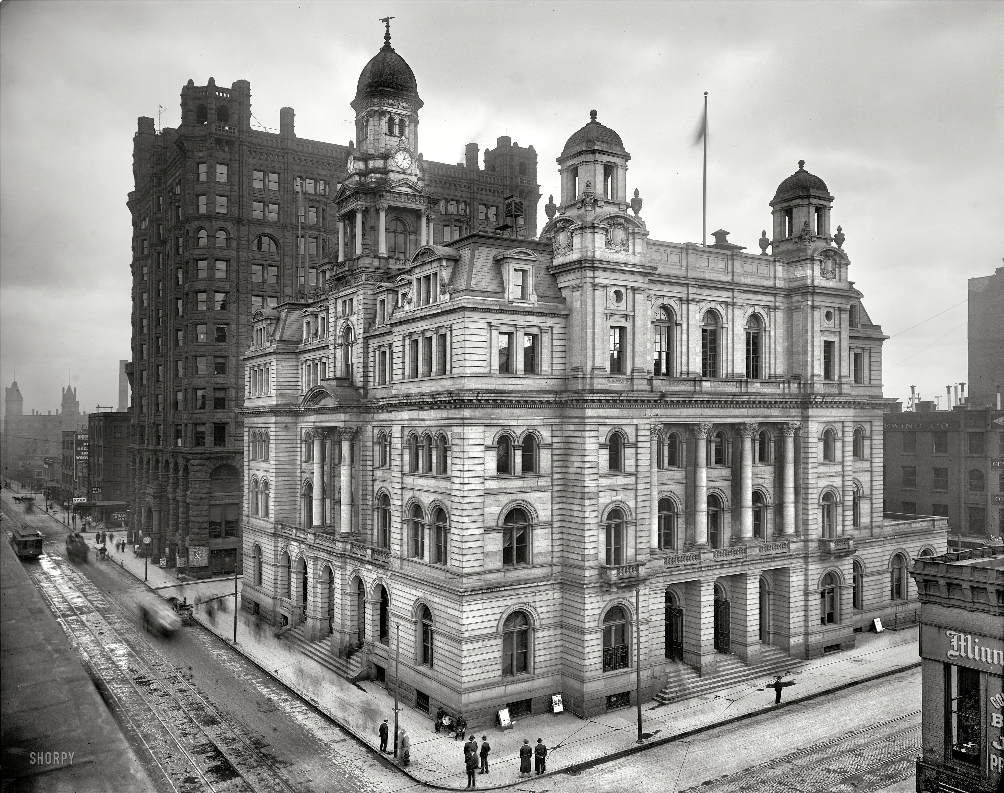 Hennepin County, Minnesota, circa 1908. "Minneapolis Post Office." Another white edifice slowly succumbs to soot. Note the turn-of-the-century boombox playing on the corner, and the many spectral pedestrians. View full size.