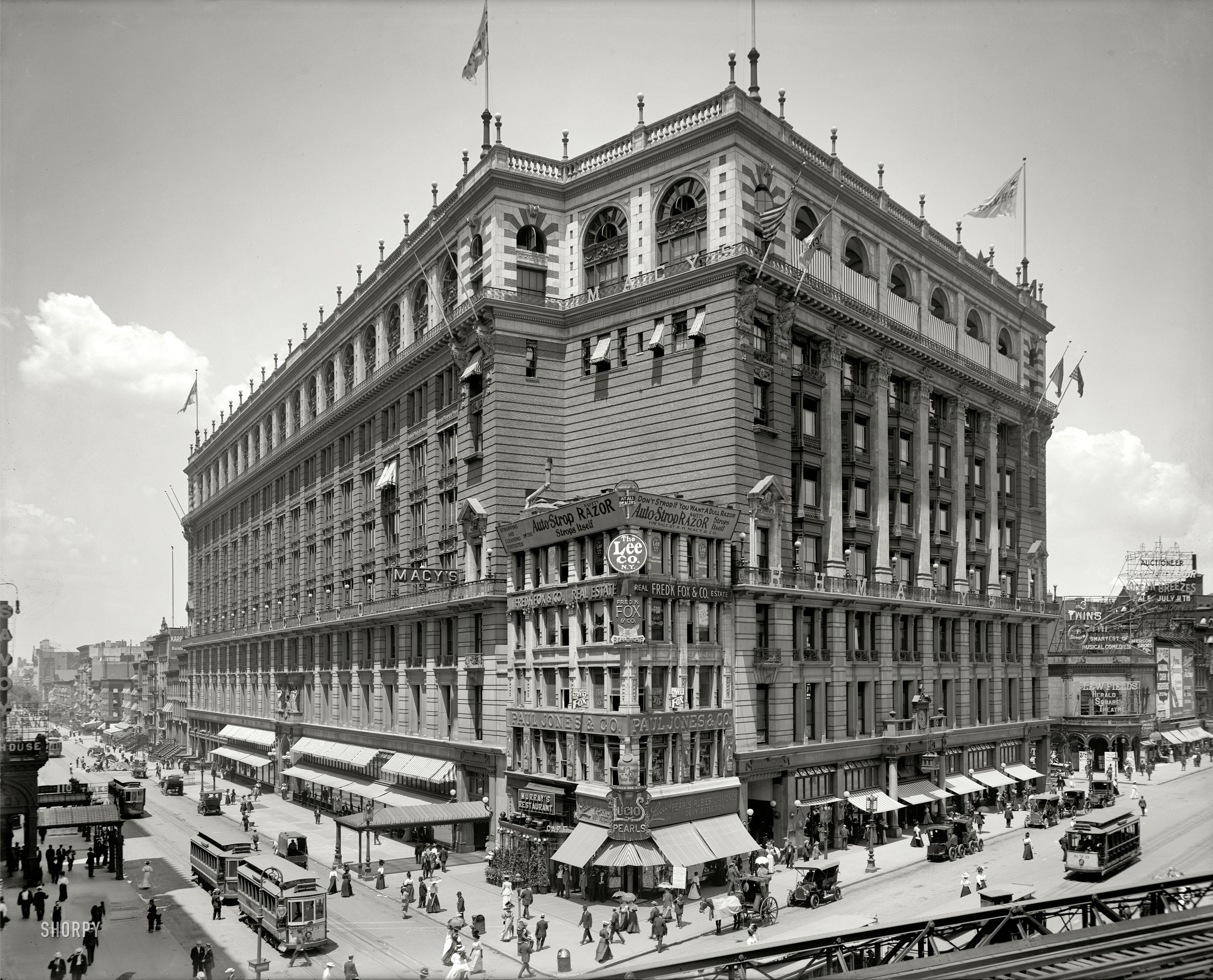 New York circa 1908. "R.H. Macy & Co., Herald Square." Broadway at 34th Street, with a glimpse of the Sixth Avenue  elevated tracks. Other Shorpy landmarks include Lucio's Pearls and a couple of the electric hansom cabs seen in a previous post. 8x10 inch glass negative, Detroit Publishing. View full size.