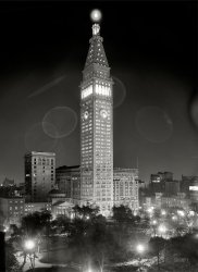 New York City circa 1910. "Metropolitan Life Insurance Company building at night." Note the 10-minute exposure time as recorded by the clock. 8x10 inch dry plate glass negative, Detroit Publishing Company. View full size.
My favorite parkI spent this sunny afternoon in Madison Square Park, embroidering and watching the installation of the latest MAD. SQ. ART exhibition.  It's my favorite NYC park, hands down, any time of year.  I must beg to differ with Mr. Mel, though.  The domed building with pediment that fronts Madison between 24th and 25th Streets is gone, replaced by a strange art deco stump.  The courthouse is on the north side of 25th Street, and its pediment faces 25th Street, not Madison.  
WowJust plain old, wow.
I like the people on the park benches who sat there, unmoving, for a goodly portion of those ten minutes. Must have been a warm night.
TimingMy first thought was also; "Oh, a ten minute exposure, how neat." But now I'm wondering why the hour hand isn't also swept a sixth of the way between 7 and 8? And how on earth do you get five people in NYC to sit still for that long?
[We see something similar in this 1943 time exposure. The hour hand might have moved in 15- or 30-minute increments. As for the sitters, they have to remain relatively still only long enough to register on the emulsion, not necessarily the entire length of the exposure. - Dave]
Whatever happened to"Success Magazine"?
New York State of MindThe low domed structure with the columns is the Manhattan Appellate Courthouse, there since 1900 and one of the busiest in the State to this day. If they turn you down, next stop is the NY State Supreme Court. The property that it was built on was owned by a NY Congressman who sold it to the city for $370,000, a phenomenal sum in those days.
2nd LookOur Madison Square Park Tipster is correct the domed structure in this photo is not the Appellate Courthouse. The courthouse is indeed on 25th St and not in this picture. After a more careful look, the domed building is a church. It was the Madison Square Presbyterian Church, a short lived structure built in 1906 and demolished in 1915. I imagine somebody made the Congregation an offer they couldn't refuse.
[The church was razed in 1919; Met Life paid $500,000 for the property. Interesting side note: Its predecessor was torn down in 1905 to make way for the main Met Life tower. - Dave]
Back to the FutureI love photos like this that make a 100-year-old scene look current. I can imagine the thoughts going through the heads of those sitting on the park benches: Lighted skyscrapers, motor cars, telephones -- we've reached the apex, things can't get any more modern ... can they"? If only they knew.
Otherworldly Positively ethereal ... that's the best word for it. Thanks for sharing this. Another instant classic -- these black and white nighttime photos are so beautiful.
Gloriously BeautifulThat is the only way I can describe this shot. It makes me think of the book "Time After time". 
The clarity is STUNNING and the subject top notch. Anyone know who the photographer was?
Don&#039;t Jump!I can't tell for sure, but is that a man standing in the belvedere at the very top of the building?  What a view HE must have had!
[That's a bell in the cupola. - Dave]
BreathtakingI share the thought of photoscream -- how could those people sitting at the park believe that things could get more modern?
Greetings from Argentina, this blog is fantastic!
Little-known factThe Met Life tower was built to withstand aerial attack by giant parameciums.
Refined datingI agree that the photo is beautiful and evocative.  The church certainly lasted more than ten years, and it was only built to replace the church that had been on the site of the Tower.  The tall building behind the church is the "north annex" of MetLife, which opened in 1919.  The lights indicate that it is already in use, so I would date the photo no earlier than 1919.
[Thankew! - Dave]
[I think you're mistaken. The Annex replaced the domed church seen in our photo. Demolition of the church commenced in 1919; below is a New York Times article from that year with an artist's sketch showing the finished annex. Which was an extension of the "old annex" -- the mid-rise structure seen in our photo behind the church. So we're going back to 1910. - Dave]
That domed buildingThe domed building at 24th &amp; Madison was architect Stanford White's 1906 Madison Square Presbyterian Church, a widely-admired masterpiece that stood less than 10 years before being demolished to make way for the full-block Metropolitan Life North Building, the "strange art deco stump" referenced below.  At 100 stories, it was planned as the tallest skyscraper in the world, but was cut off, rather literally, at 32 stories by the stock market crash in 1929.
[Not quite. The "stump" replaced the annex that replaced the church, which stood for 13 years. The church was demolished in 1919 to make room for an extension of the "old annex" seen behind it in our photo. The resulting structure, known simply as "the annex," was completed around 1921. The North Building (the "Art Deco stump"), which replaced the annex, was completed in 1932. - Dave]
Bat signalThose circle effects almost make it look as if the Police Chief is signaling for help.
Sunset Towertterace's comment about how it must have been a warm night got me thinking about what time of year this might have been - for the sky to be dark by 7:20-7:30, it must not have been in the summer. But in order to pinpoint further the time of year, I looked at the lighting conditions in the photo - I believe that the MetLife tower itself is illuminated by the setting sun. There does not appear to be any other light source that would illuminate the building so far up the tower. And the direction is right, as the photographer is situated across the park to the west of the building. According to sunrisesunset.com, sunset was around this time in early April and early September, 1910.
Sniper?Is that a person lurking at the very top?
[The dark shape in the cupola is a bell -- three tons, bronze. - Dave]
My workplaceWhat a great shot. In the mid 1980s I worked in the tapered part at the top, on the floor with the arched windows, but on the opposite side from this picture. We had fantastic views!
(The Gallery, DPC, NYC)