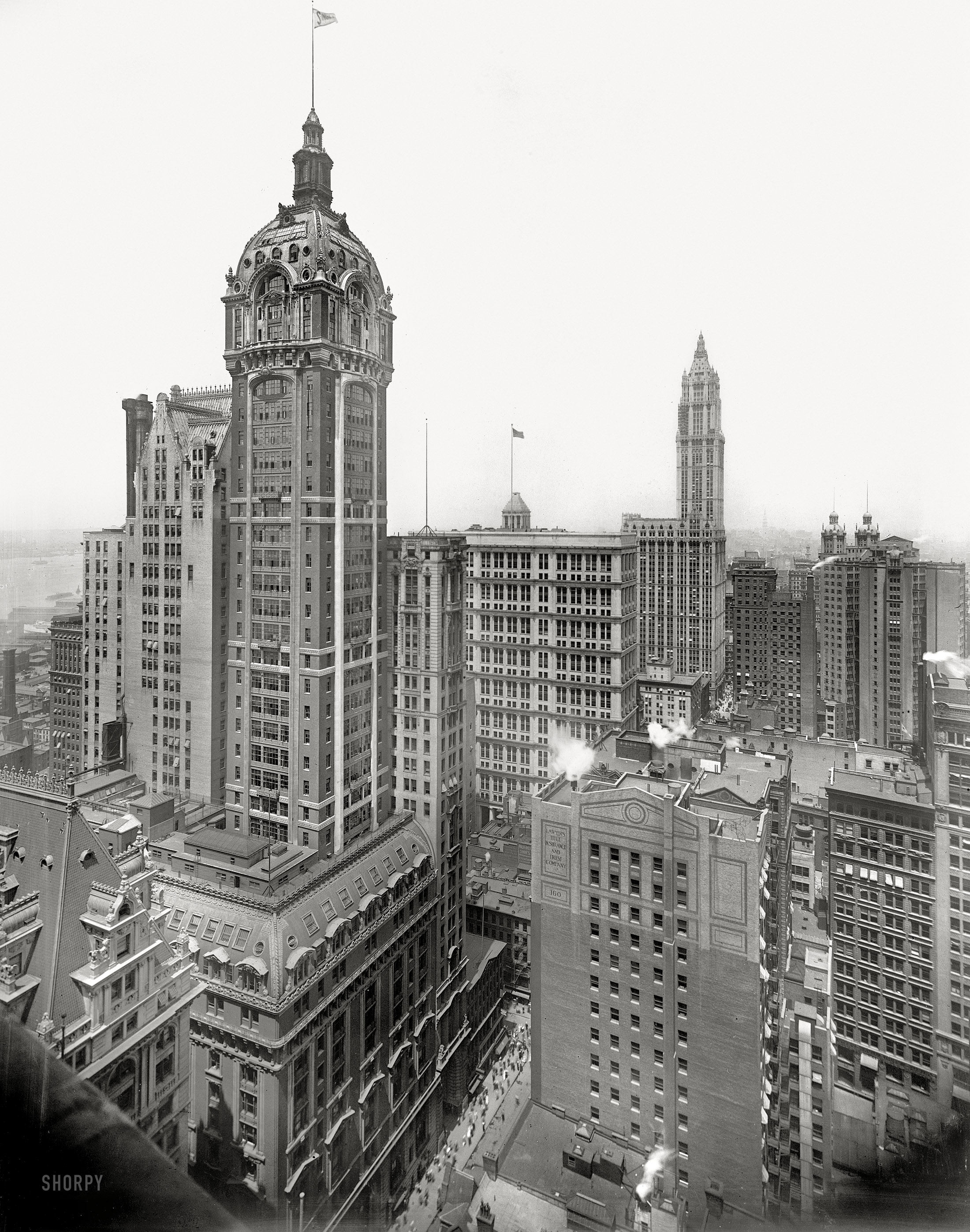 New York circa 1913. "The Singer Building." Rising in the distance, the Woolworth Building under construction. Detroit Publishing Company. View full size.