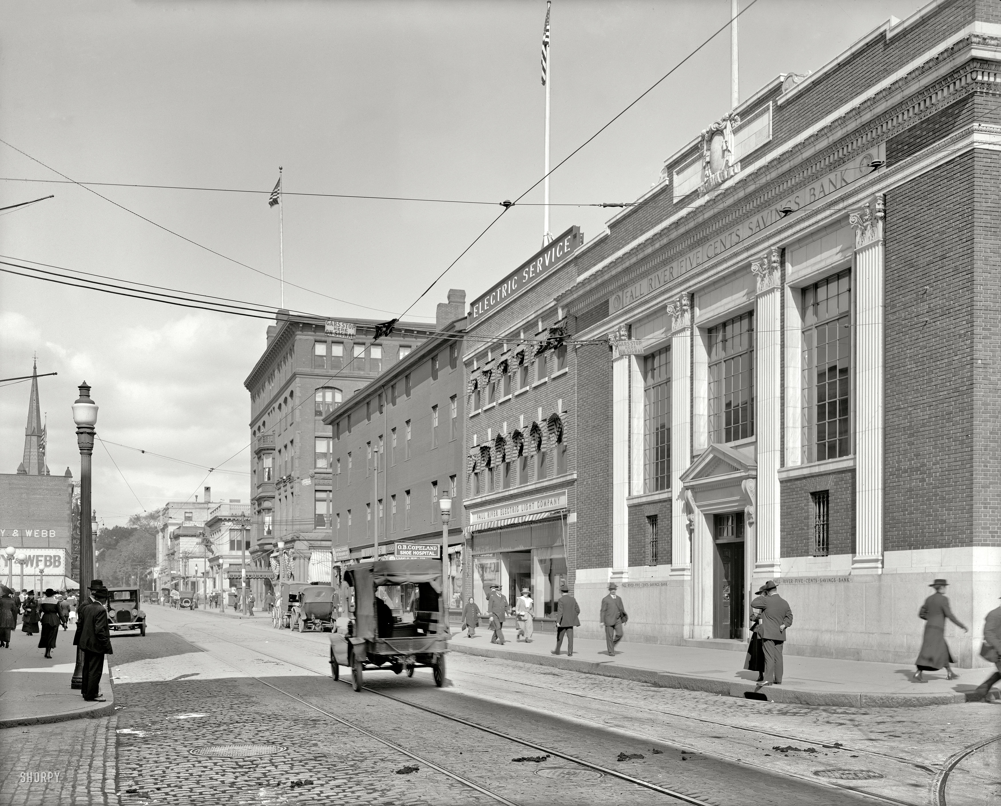 Circa 1915, another look at Main Street in Fall River, Massachusetts. Where the Shoe Hospital and Five Cents Savings Bank are mere steps apart. 8x10 inch dry plate glass negative, Detroit Publishing Company. View full size.