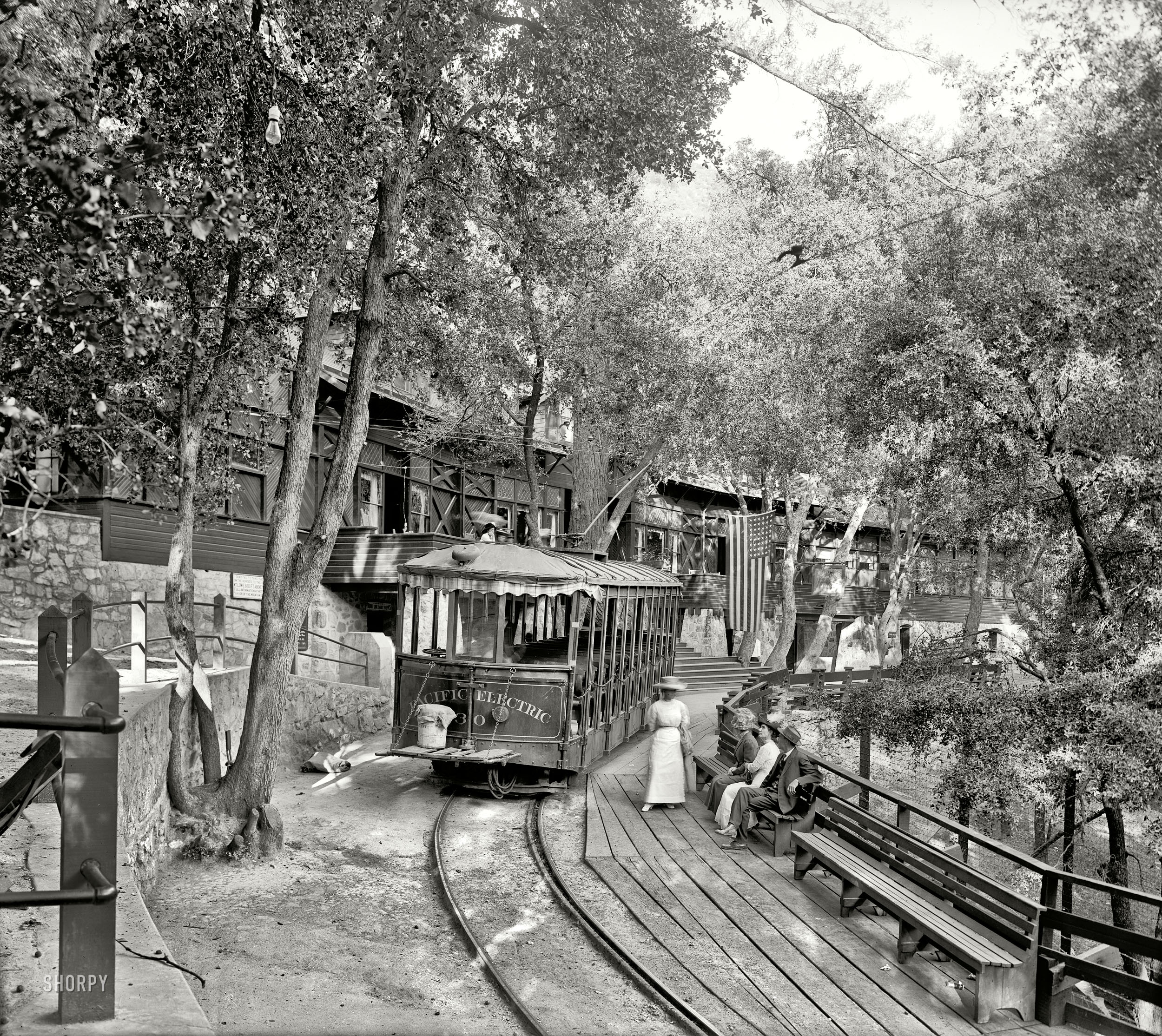 Mount Lowe, California, circa 1913. "Electric car at Ye Alpine Tavern, Mount Lowe Railway." This Swiss-style chalet in the San Gabriel Mountains was the upper terminus (elev. 5,000 feet) of an 1890s scenic and incline railway that started in Altadena, with streetcar connections all the way to the main terminal at the Pacific Electric Building in Los Angeles. The railway and associated resorts, including the 70-room Echo Mountain House, were gradually obliterated by fire and flood until, by 1940, nothing was left. Detroit Publishing Co. View full size.