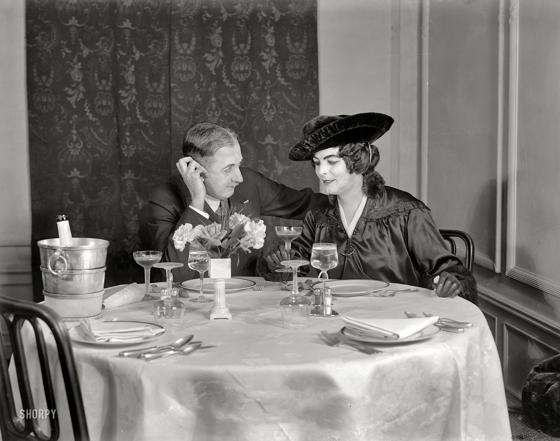 Circa 1915. "Couple at champagne supper." Anyone recognize their uncle here? 8x10 inch dry plate glass negative, Detroit Publishing Company. View full size.