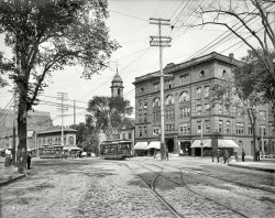 Portland, Maine, circa 1904. "Congress Square." 8x10 inch glass transparency (something of a novelty for this collection), Detroit Publishing Co. View full size.
Flatiron WannabeI see they added one story to the skinny building since 1904.
Getting AheadQuite a diverse lot of men's hats.
Great PhotoTransparency? I had no idea there was such. It seems to have some speed to to too. I will have to check into this! Thanks much.
[To to too? A transparency is just a copy of the original glass plate negative. Both of which are transparent. When you copy a negative you get a positive, which can then be projected as a lantern slide.- Dave]
Gotcha! Thanks much.
+104Below is the same view (looking north on Congress Street from High Street) taken in October of 2008.
Office SuppliesNow we know where the first Staples stores was, before Mr. Staples bought out his two partners.
Precious ScenariosProbably a Saturday, maybe a Sunday.The two young ladies crossing the street while horse and carriage wait between the church and the pharmacy in the "skinny building". The two young girls sitting on the curb sharing secrets while their older sister or Mom stands waiting for who knows what. The elderly gent sweeping up the mornings leaves and horse puckey. And the trolley cars filled with well dressed folks, all shaded by the mantle of those damn telephone/telegraph/electrical wires, which is about all I can see when I look out of most of windows of my apartment. As a retired photographer, I have grown to despise the early use of poles that are now too expensive to relocate to underground. Grumble.
(The Gallery, DPC, Streetcars)