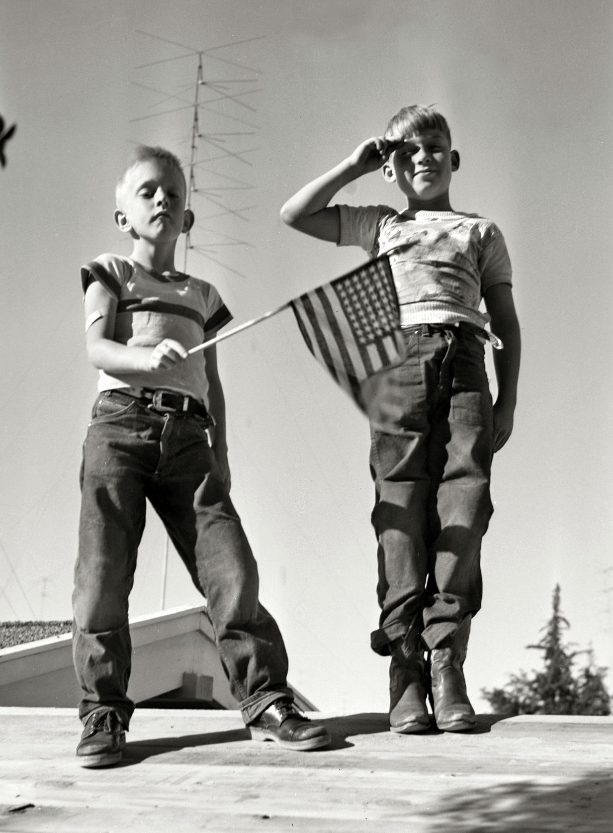 Bill Bliss and friend playing on the roof in the mid-1950s in Southern California. I don't know for sure if this was actually taken on the Fourth of July but it's patriotic nonetheless. View full size.