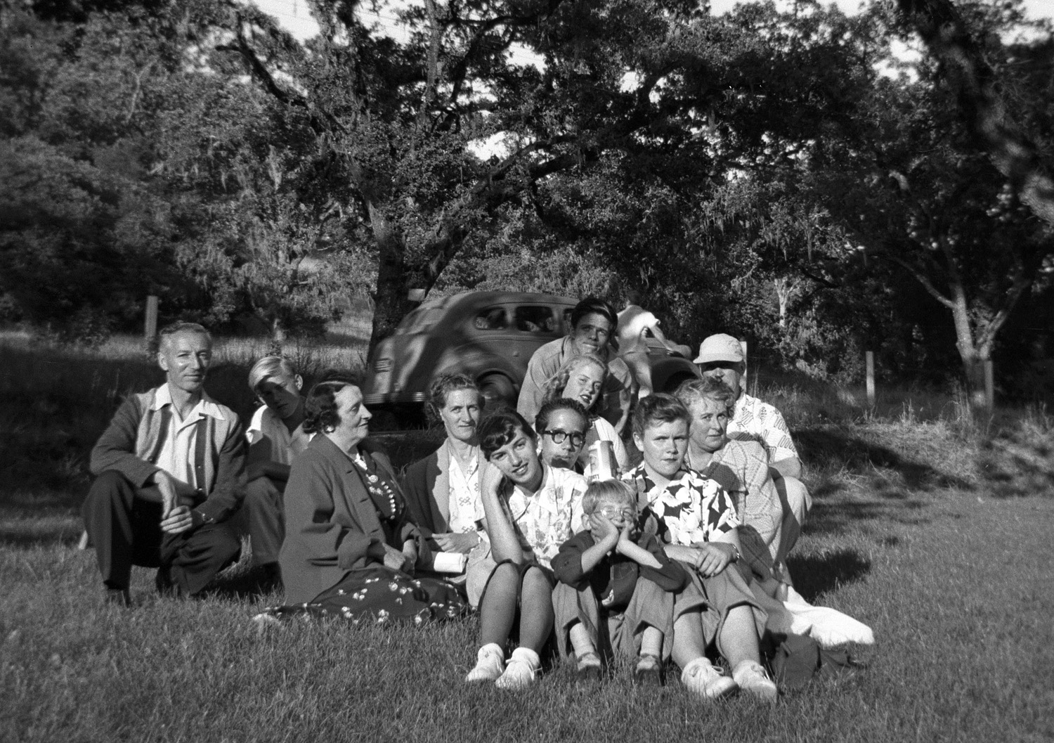 Interpreting facial expressions is a favorite Shorpy pastime, so herewith I present those of my family and friends for your speculations. Granted, some are influenced by the angle of incoming solar radiation. To the best of our recollections, this was a church picnic at Boyes Hot Springs, California. My father is at the left, my mother in the center looking at the camera, my sister propping her head on her hand, my brother over her shoulder. I'll let you guess which one is me, but as a hint he just might be the one who seems to be thinking: "I'm bored. Why can't I be home reading my comic books?" This snapshot, clicked off by a friend with my sister's Duaflex, benefited from one of those happy combinations of circumstances: nice sunlight angle and an exposure perfectly suited to the camera's fixed f-stop for Verichrome film (cropped down from a 2-1/4 square negative). Still, I rather think the shot is made by the lady who apparently didn't hear "Watch the birdie."  View full size.
