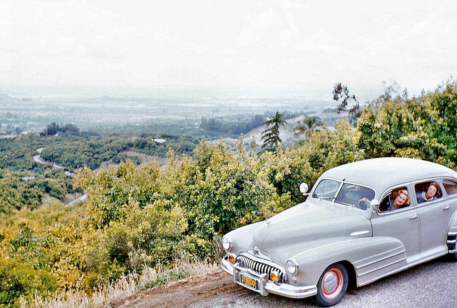 March, 1955. Cruising somewhere in the La Habra Heights, Orange County, Calif. My mom behind the wheel, neighbor in the back seat. View full size.