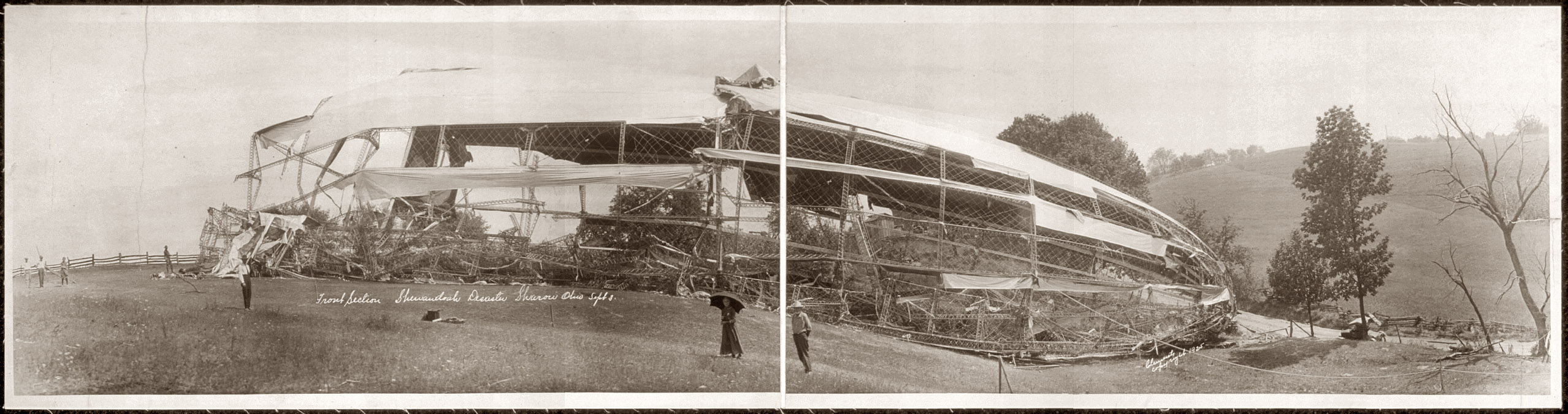Sept.3, 1925. Front of the USS Shenandoah near Sharon, Ohio, the day after it fell to earth in three sections with the loss of 14 lives. Twenty-nine survived. Panoramic photo by Rell Sam Clements. View full size.
