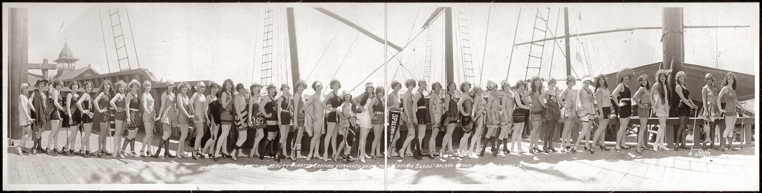 Jewell Pathe's Bathing Beauty Pirates capture Vitagraph Ships for "Captain Blood" in Balboa Beach, California, June 15, 1924. Photograph by M.F. Weaver. View full size