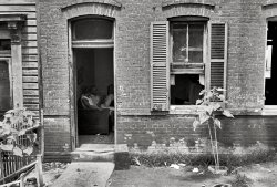 September 1935. Washington, D.C. "Front of Negro home near Capitol. Interiors of these homes vary little. A chair or two and a table, a bed and perhaps an extra mattress on the floor cares for six to ten people." 35mm nitrate negative by Carl Mydans for the Farm Security Administration. View full size.