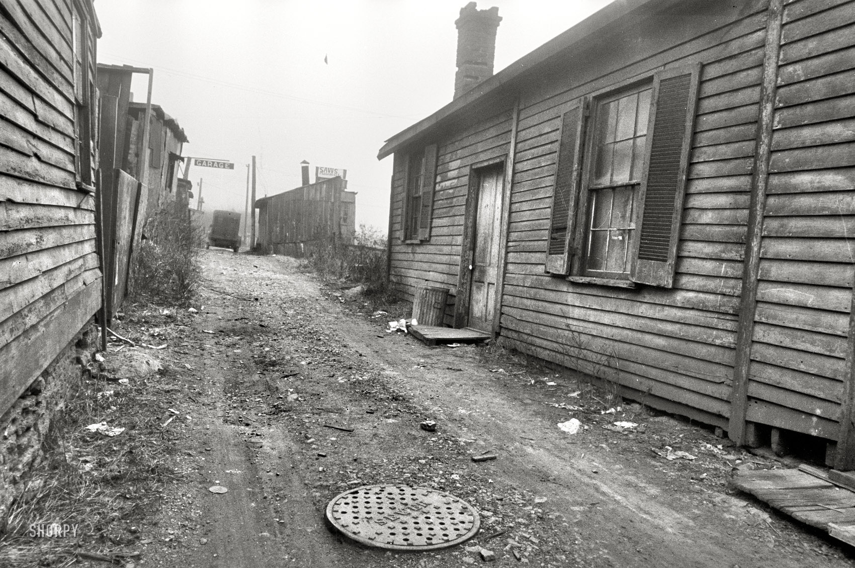 December 1935. "Hamilton County, Ohio. Cincinnati slum dwellings." An alleyway view of the "Garage" sign seen in the previous post. 35mm nitrate negative by Carl Mydans for the Resettlement Administration. View full size.